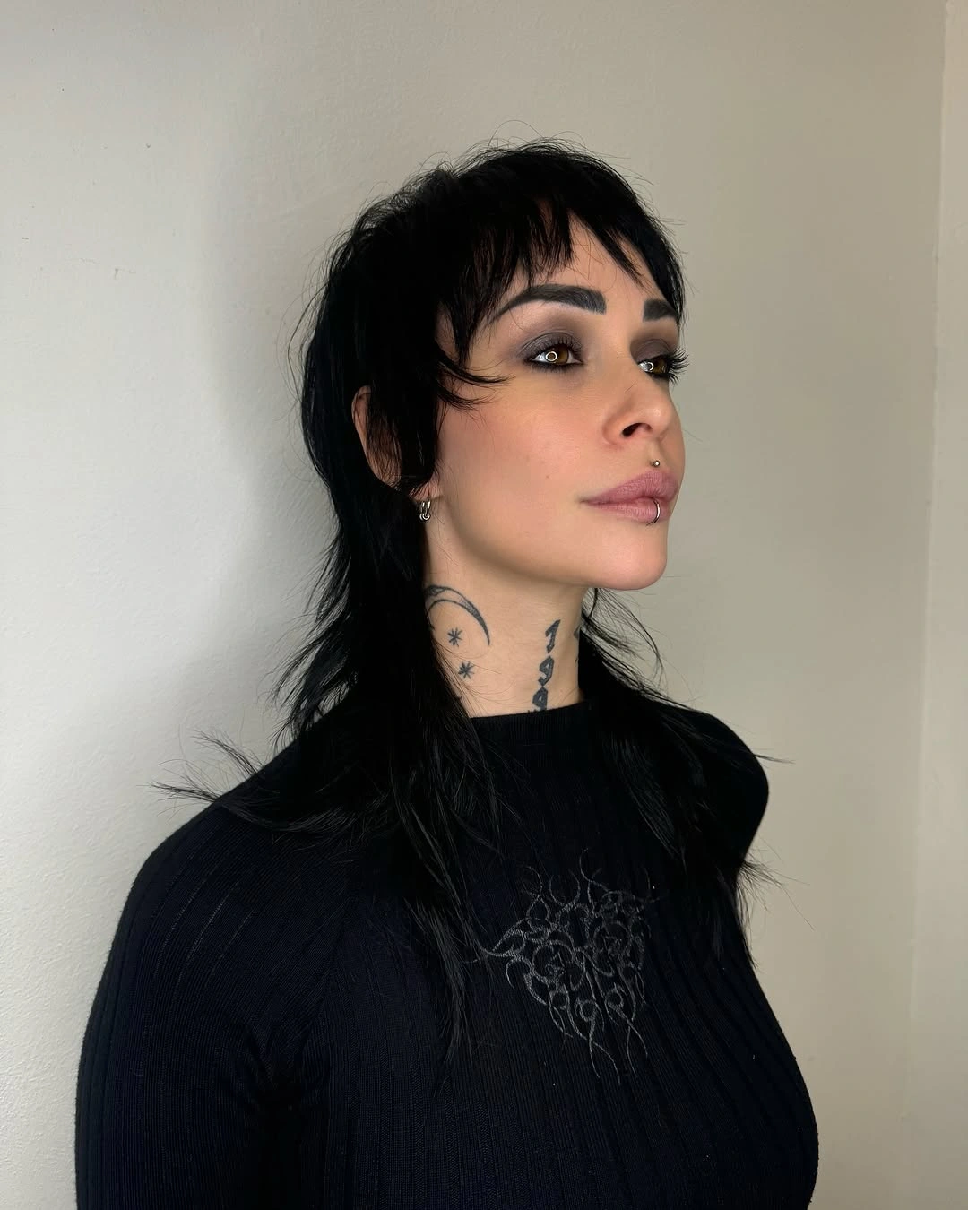 Dark shaggy layered cut with bangs and longer nape