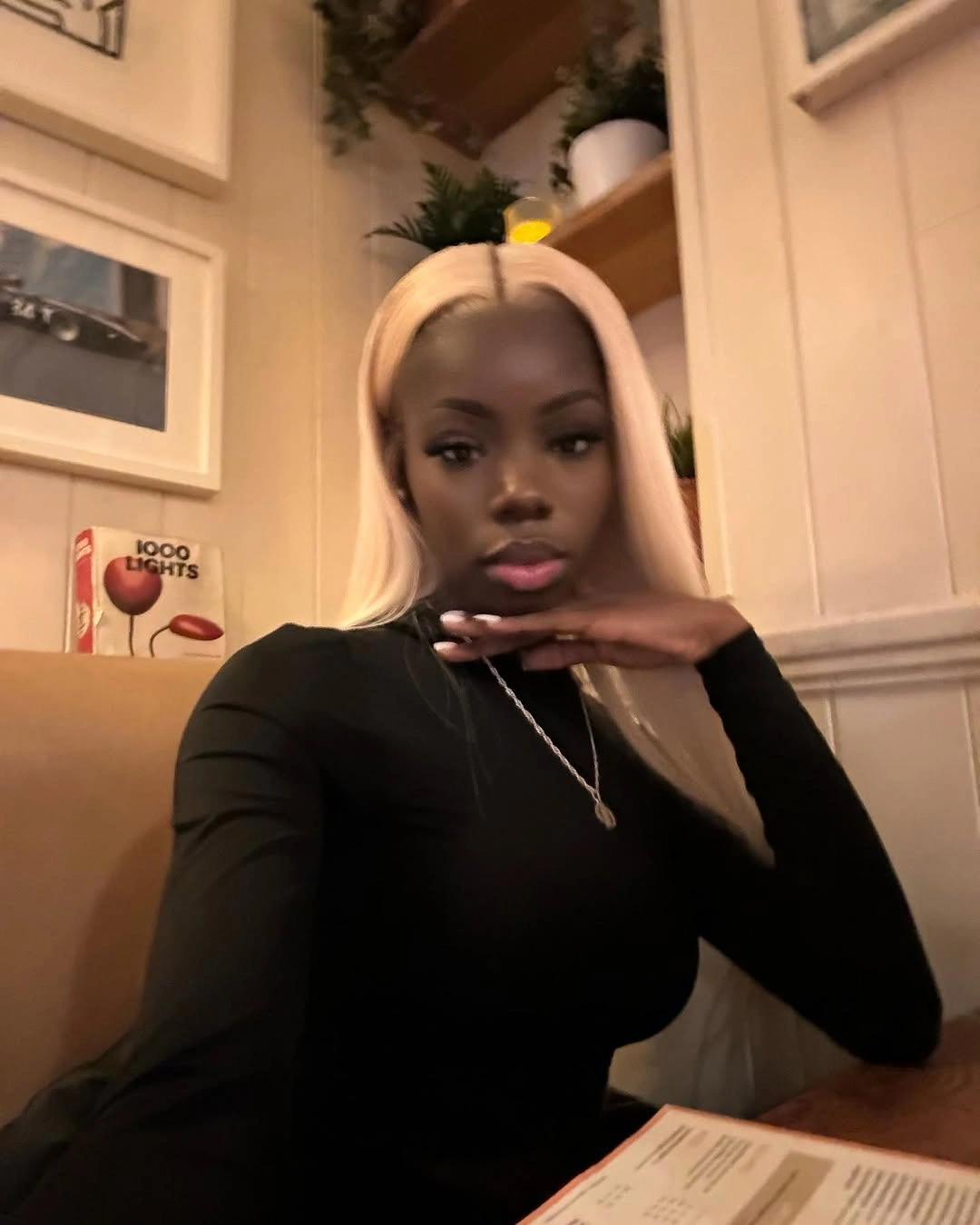 Long straight blonde hair with center part indoors