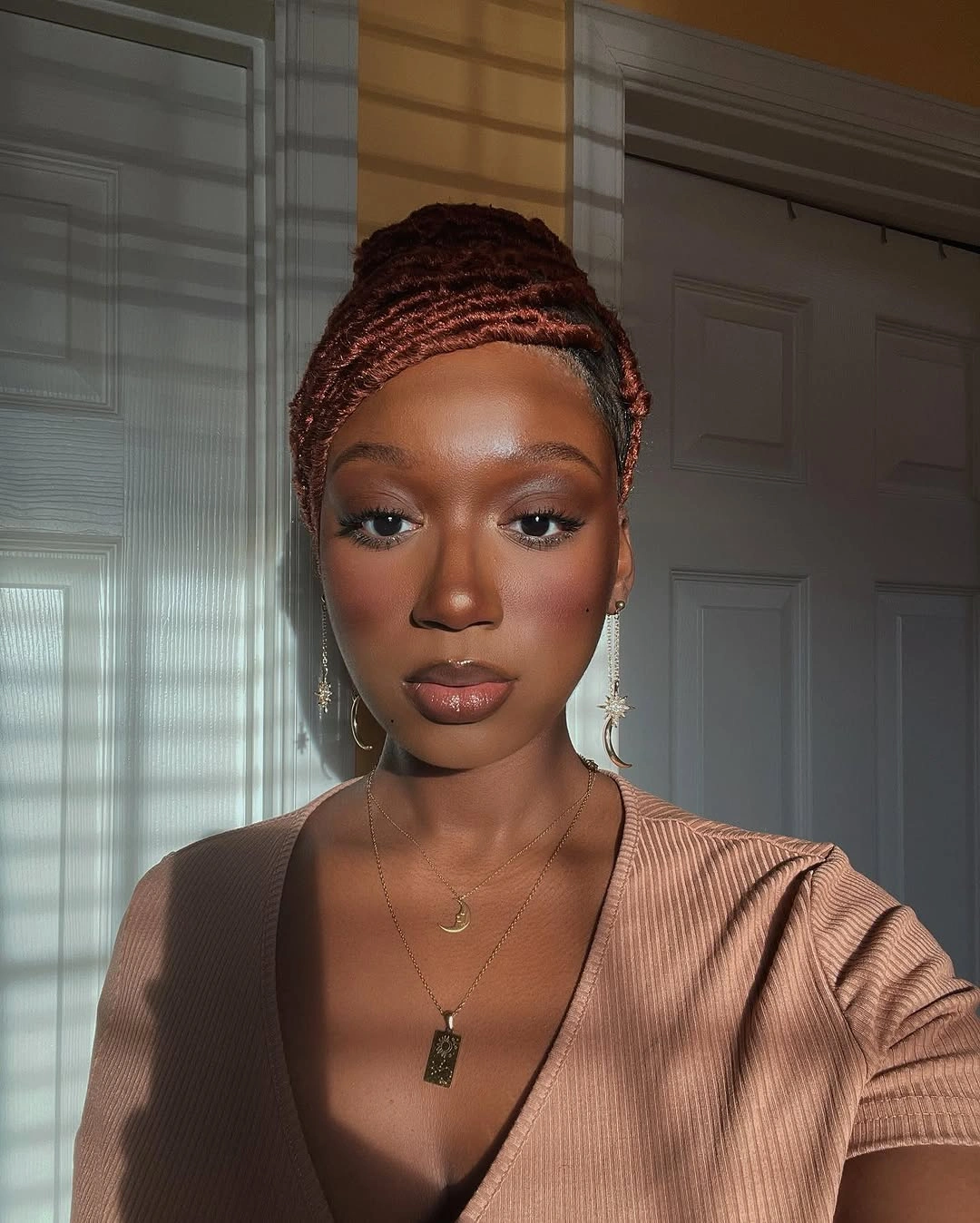 Copper braided updo with close rows in window light