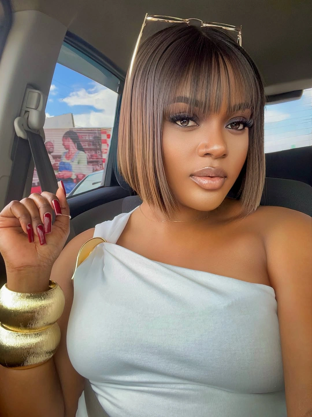 Straight blunt bob with full bangs and warm brown tone