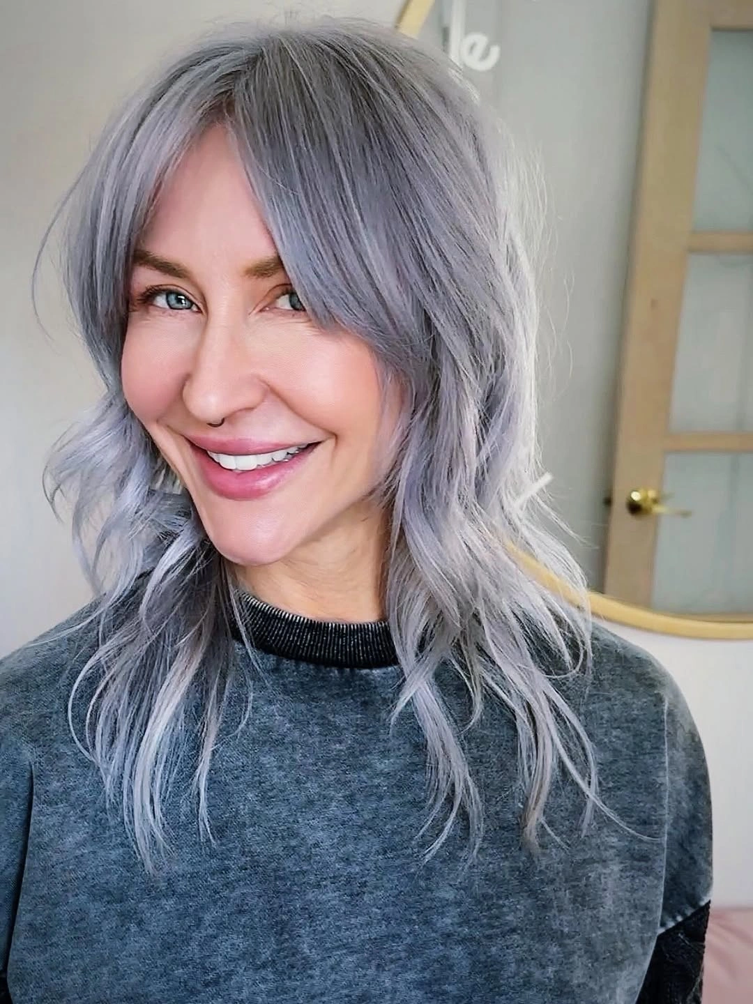 Silver-gray medium hair with center part and loose waves