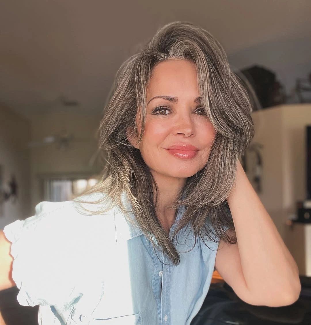 Medium gray-brown hair with deep side sweep and layered ends