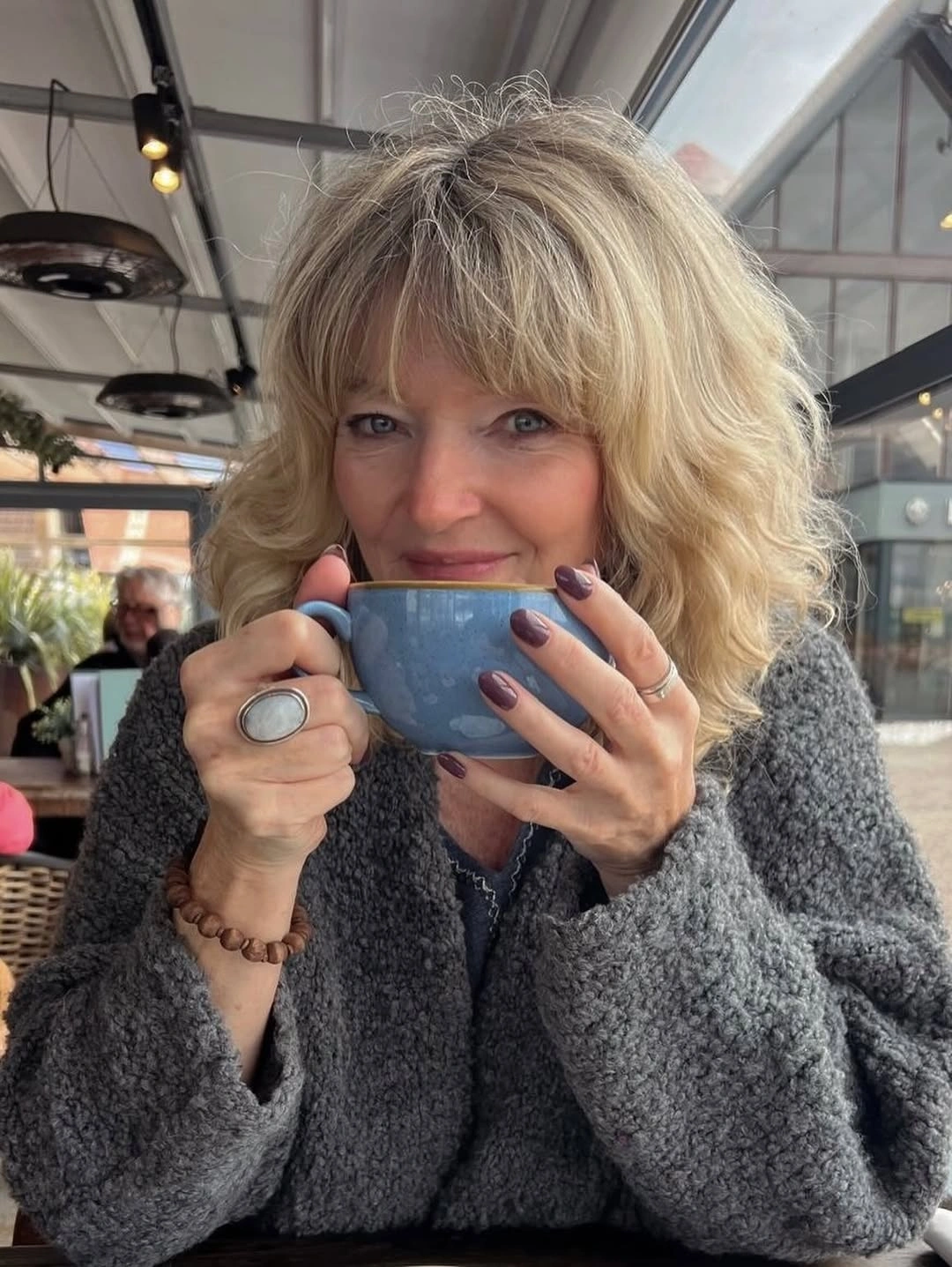 Blonde medium hair with bangs and soft side waves