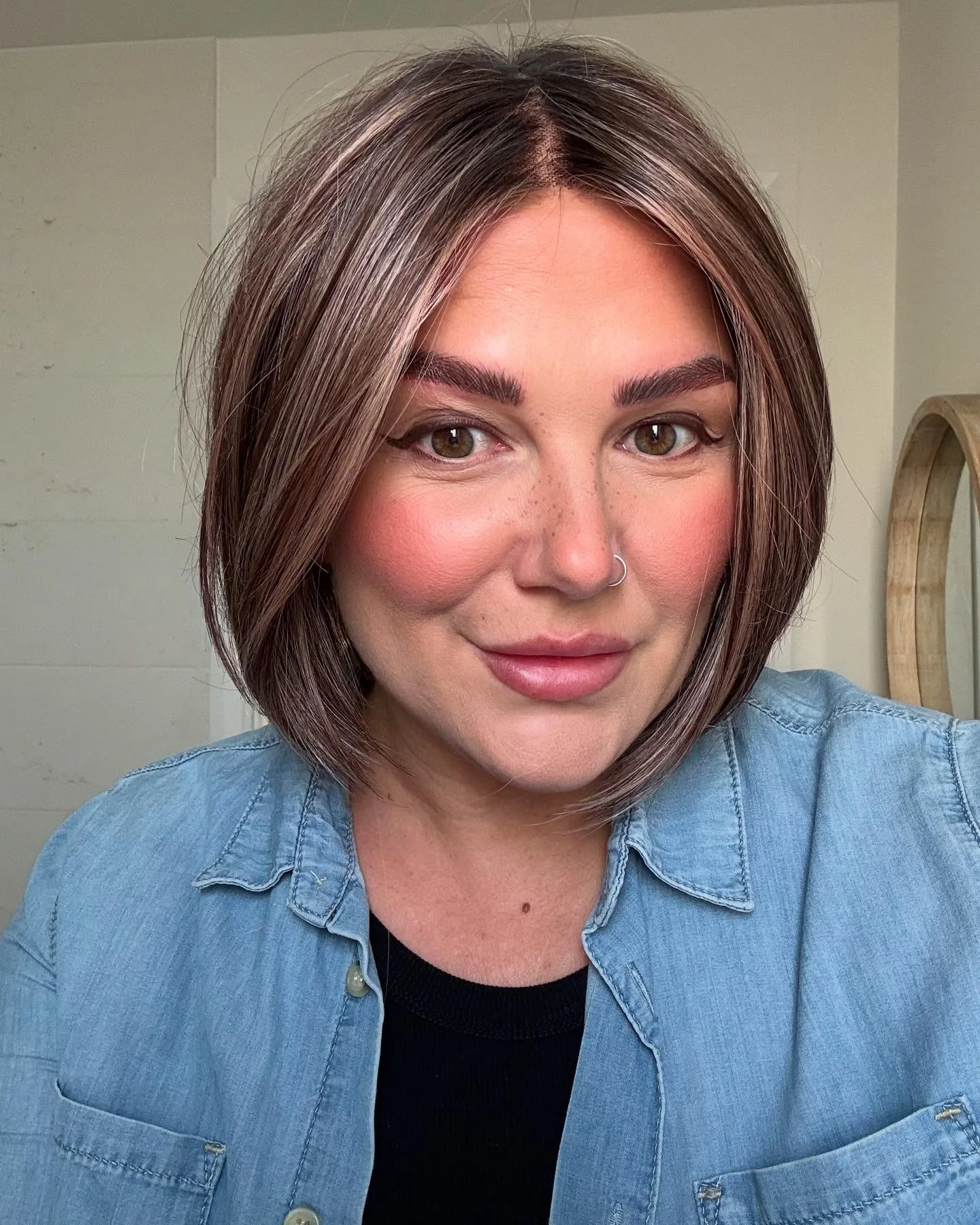 Short brunette bob with center part and smooth sides
