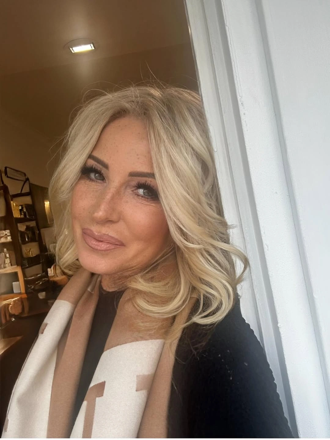 Medium blonde layered waves with broad curls near shoulders