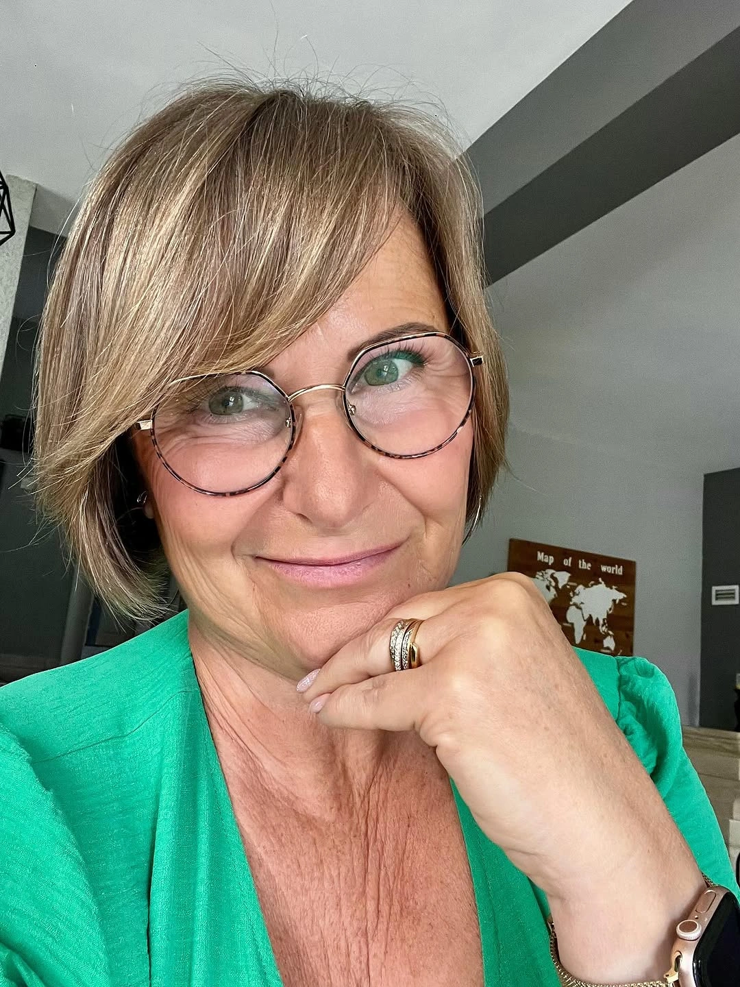 Short highlighted side-swept haircut with diagonal fringe and glasses