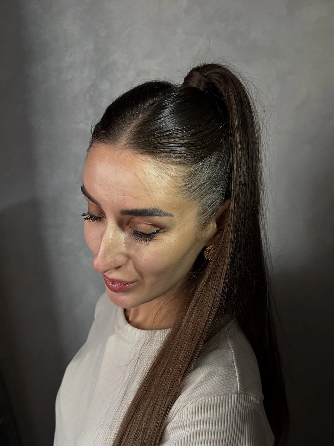 Long brunette half-up hairstyle with sleek top and straight lengths