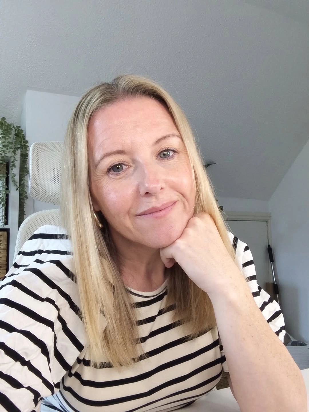 Long straight blonde hair with center part and smooth fall