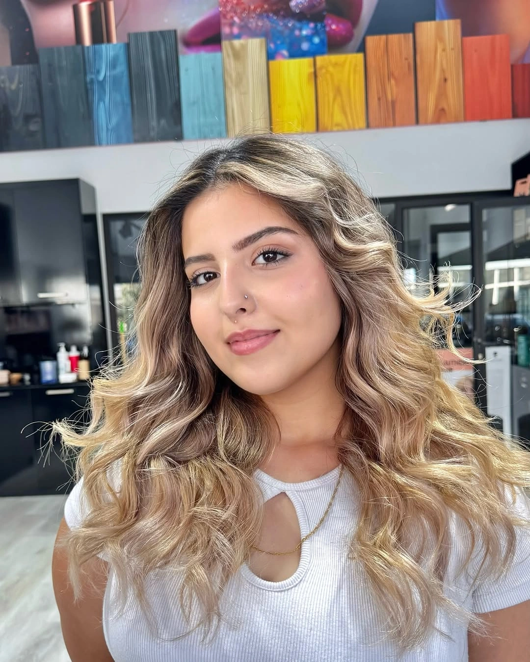 Long blonde wavy hair with broad curls around face