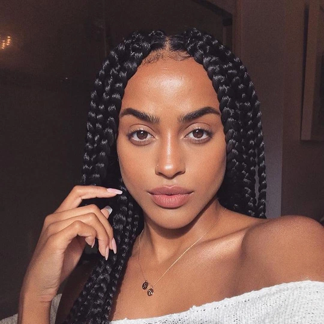 Long black braids with centered part and smooth front