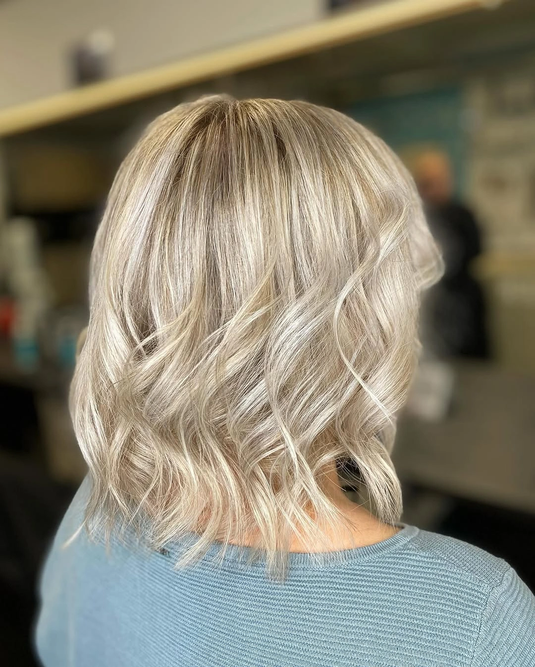 Short blonde wavy bob from back with airy ends