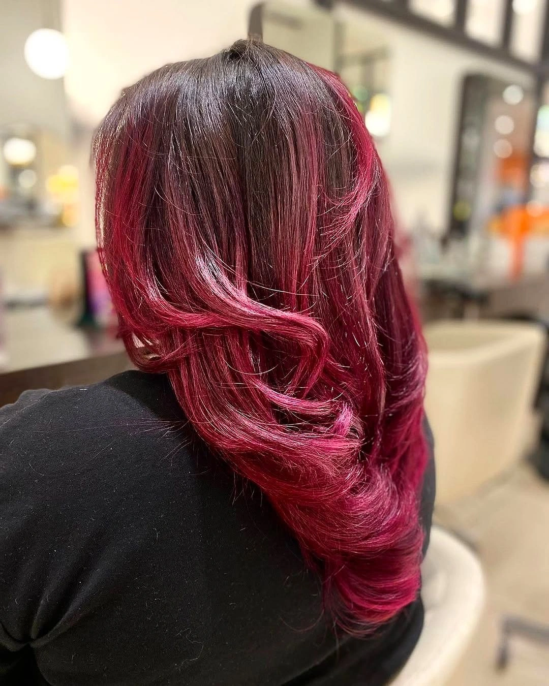 Long layered red and magenta hair with sweeping waves