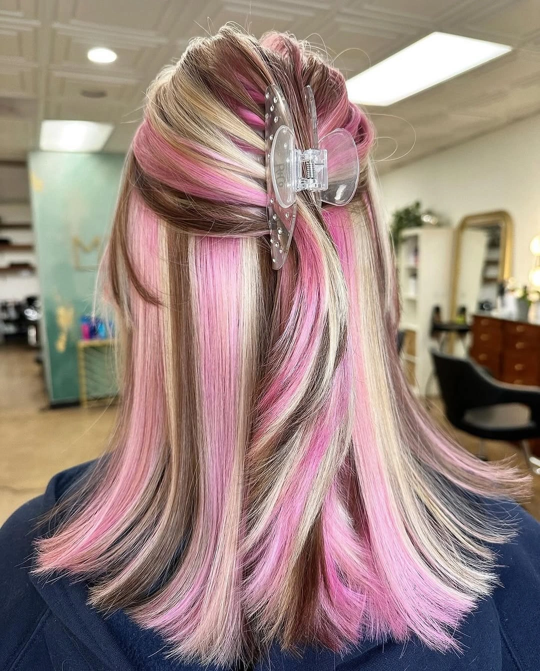 Pink and pale blonde panels in clipped half-up hair