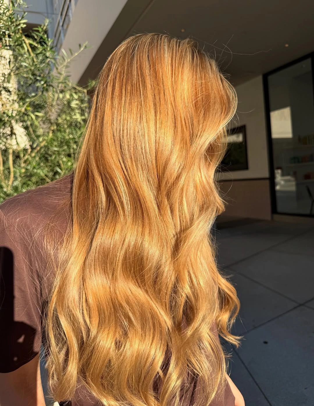 Long golden copper-blonde hair with soft waves