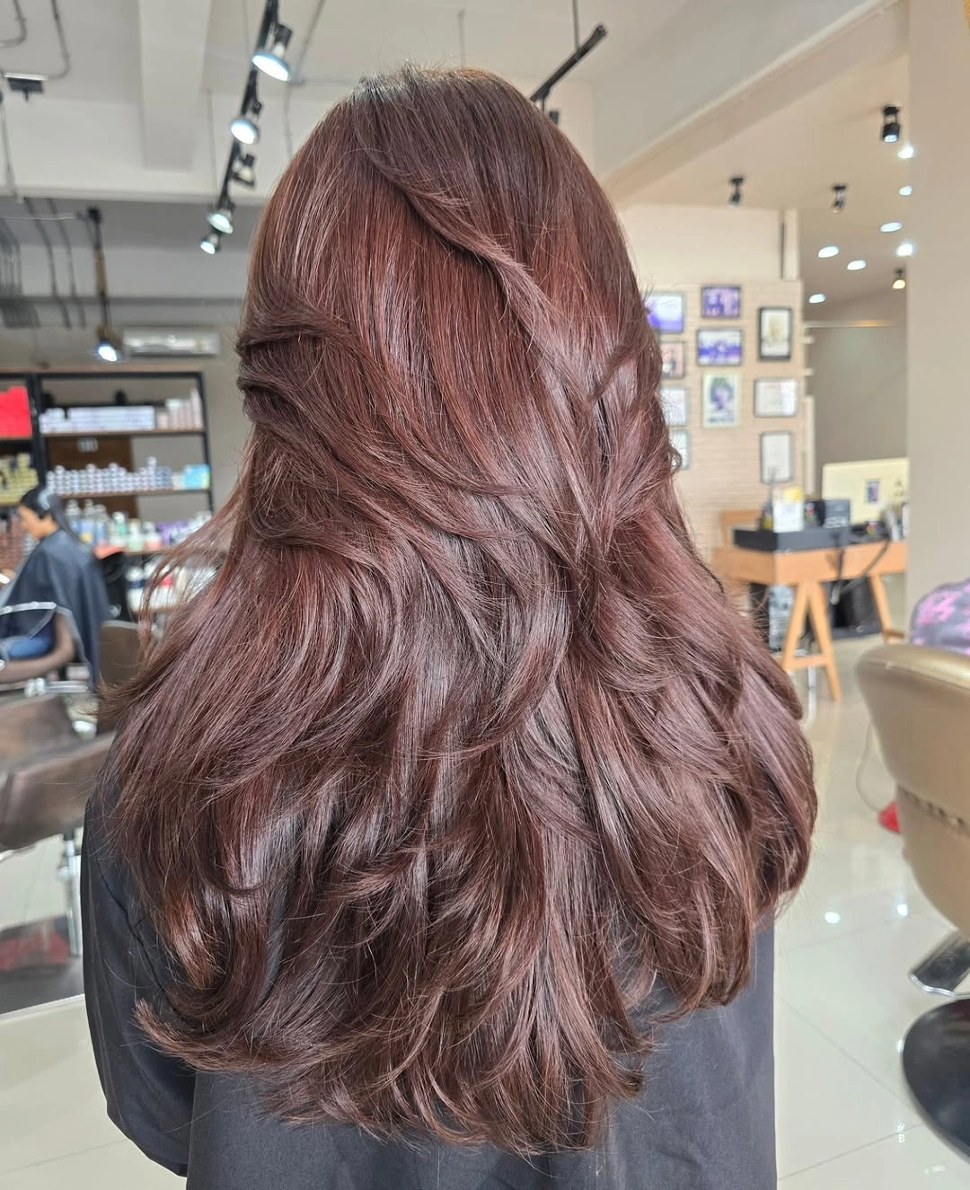 Long rose-brown layered waves viewed from the back