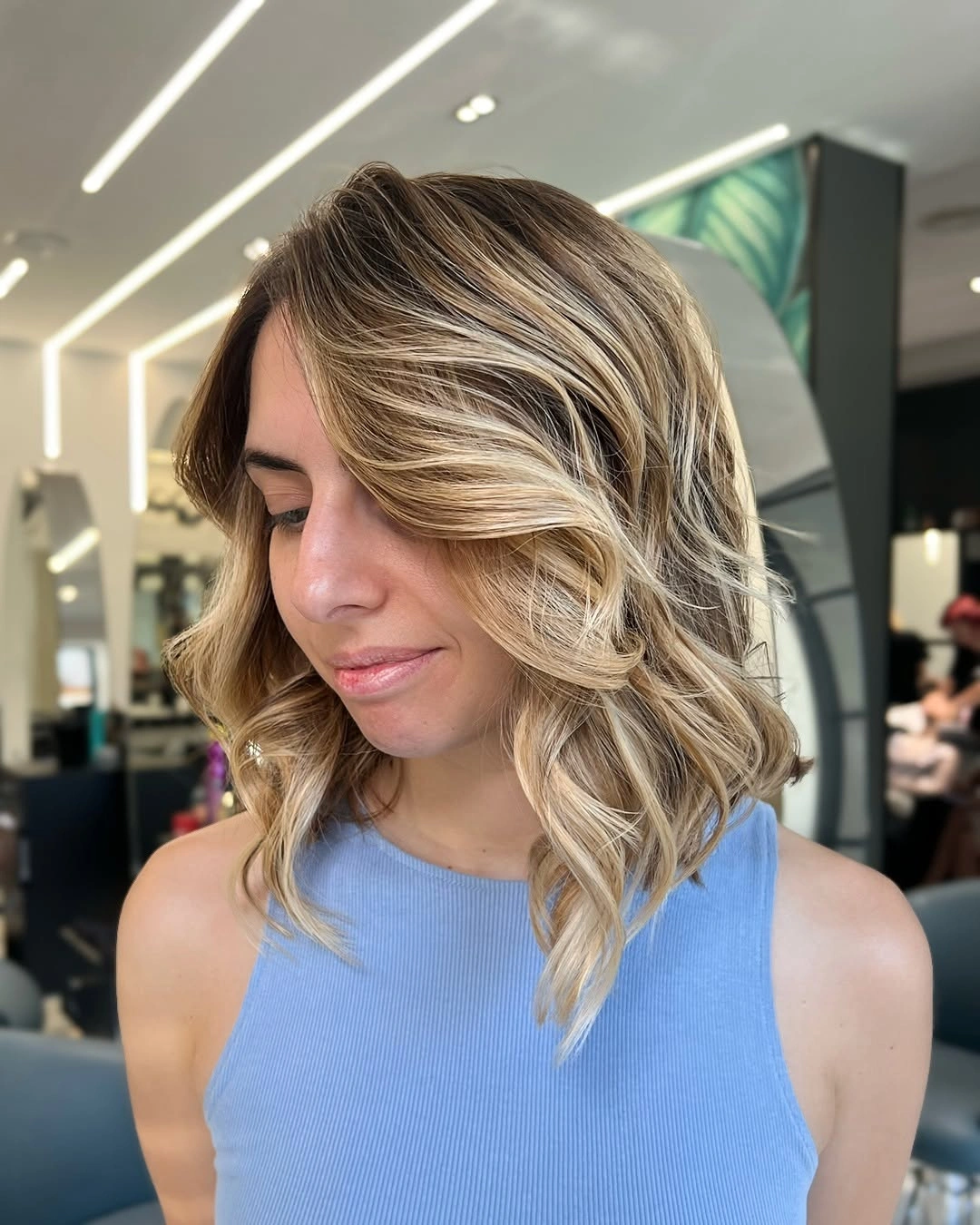 Shoulder-length blonde waves with side-swept front pieces