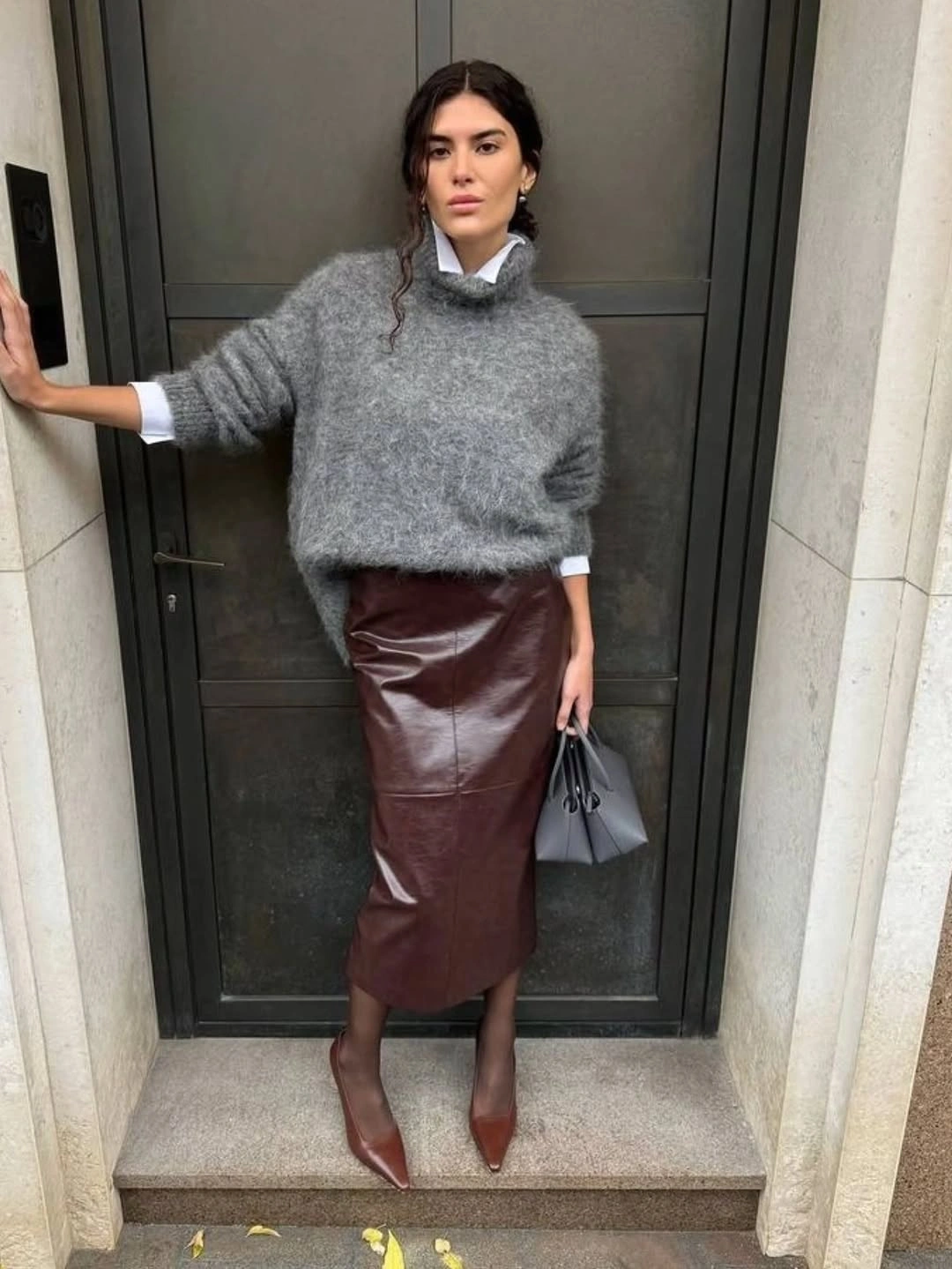 Fuzzy gray sweater with glossy burgundy skirt and brown heels