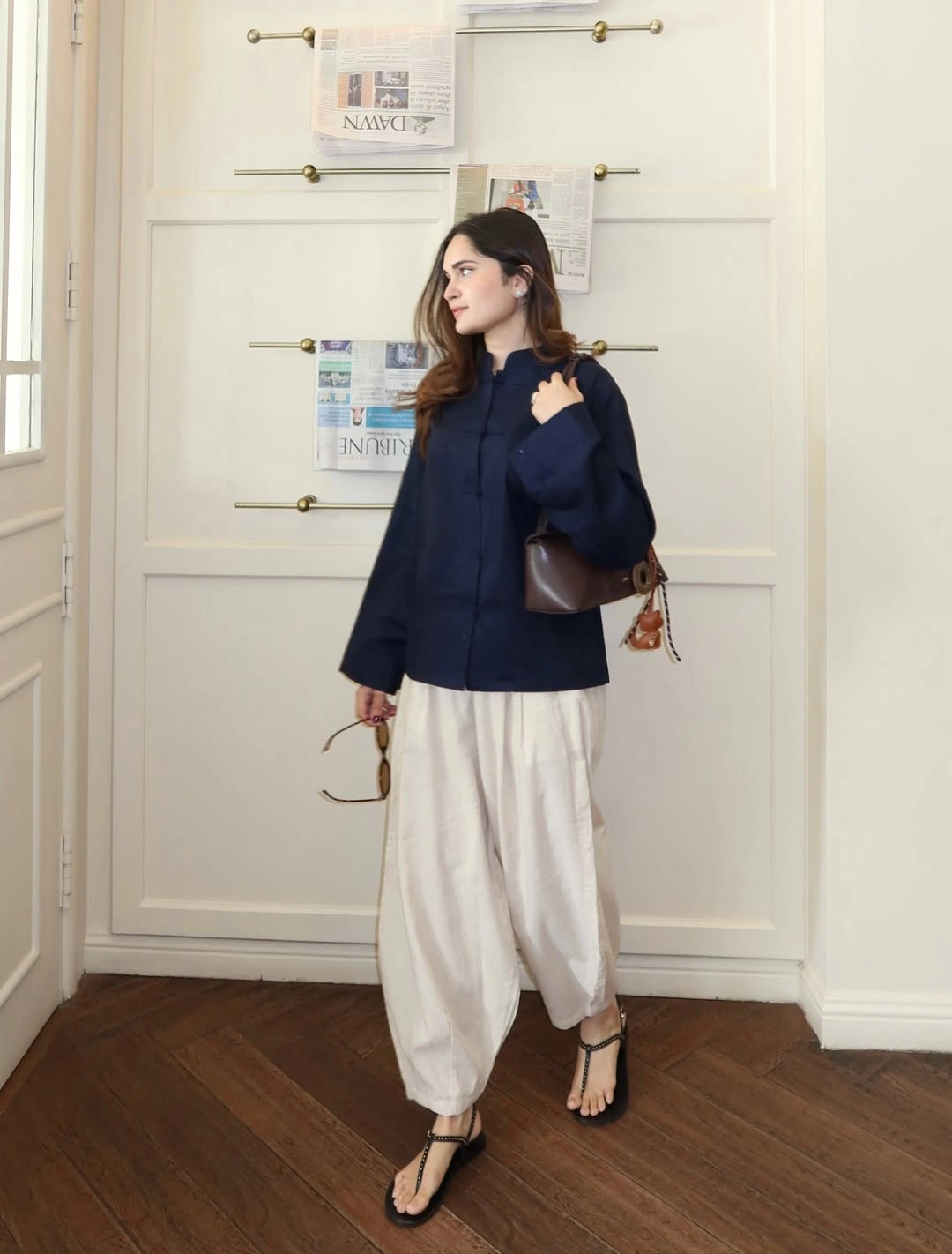 Navy loose top with gathered white trousers and black sandals