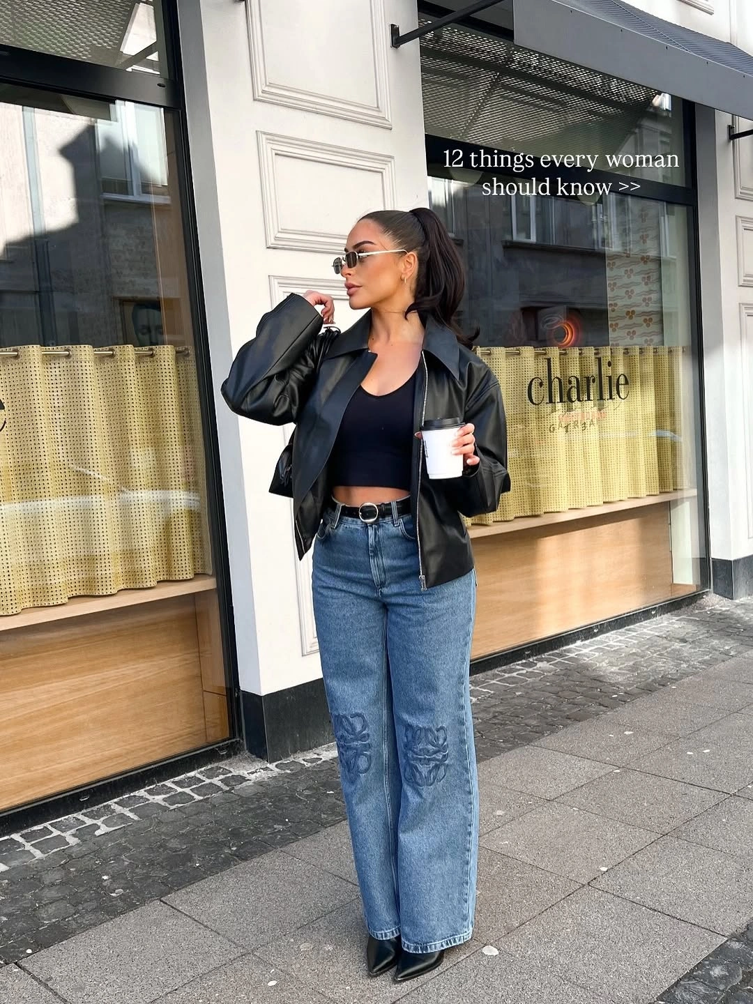 Smooth black cropped jacket with wide jeans and pointed shoes