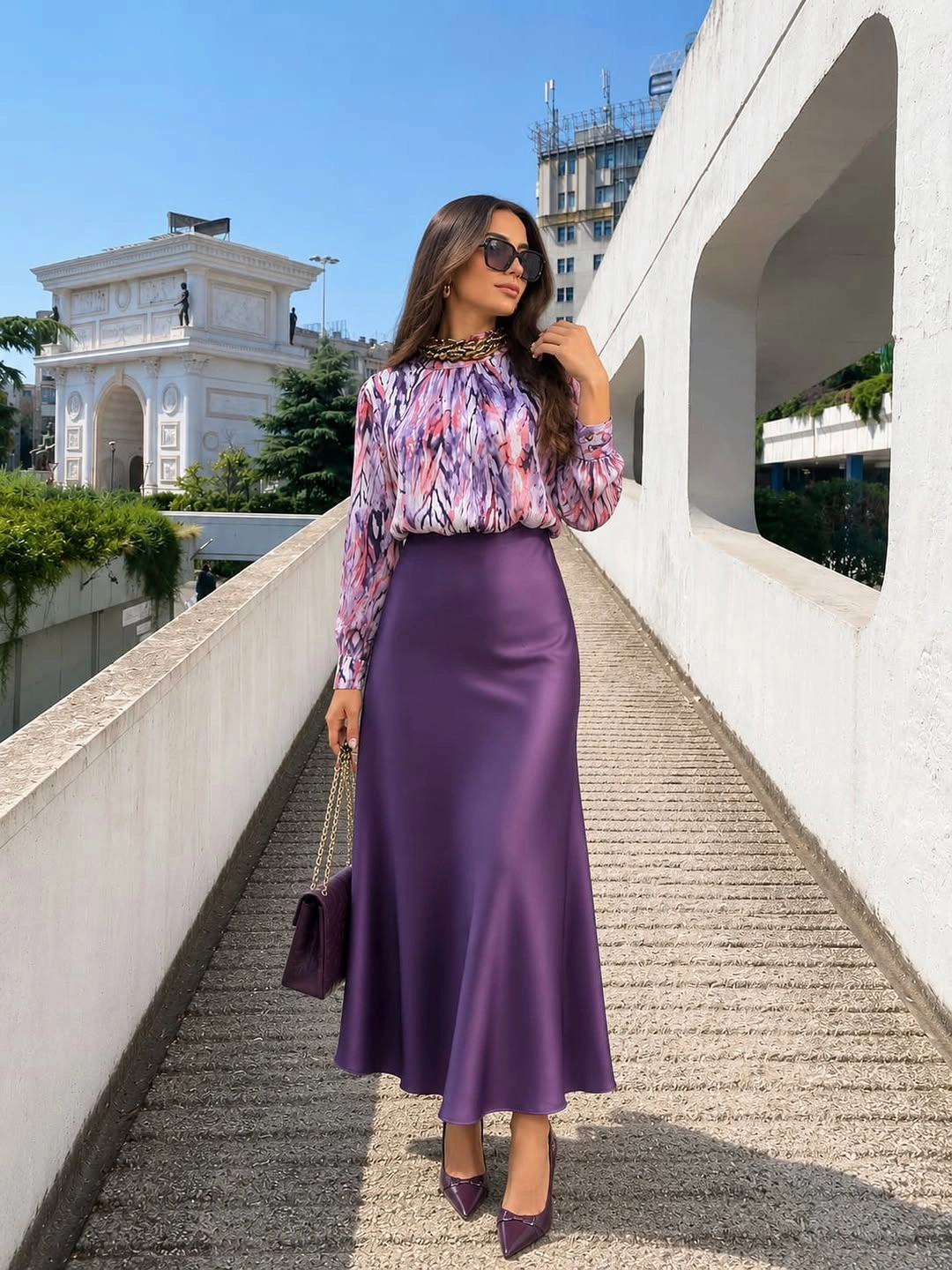 Printed blouse with glossy purple skirt and matching pointed shoes