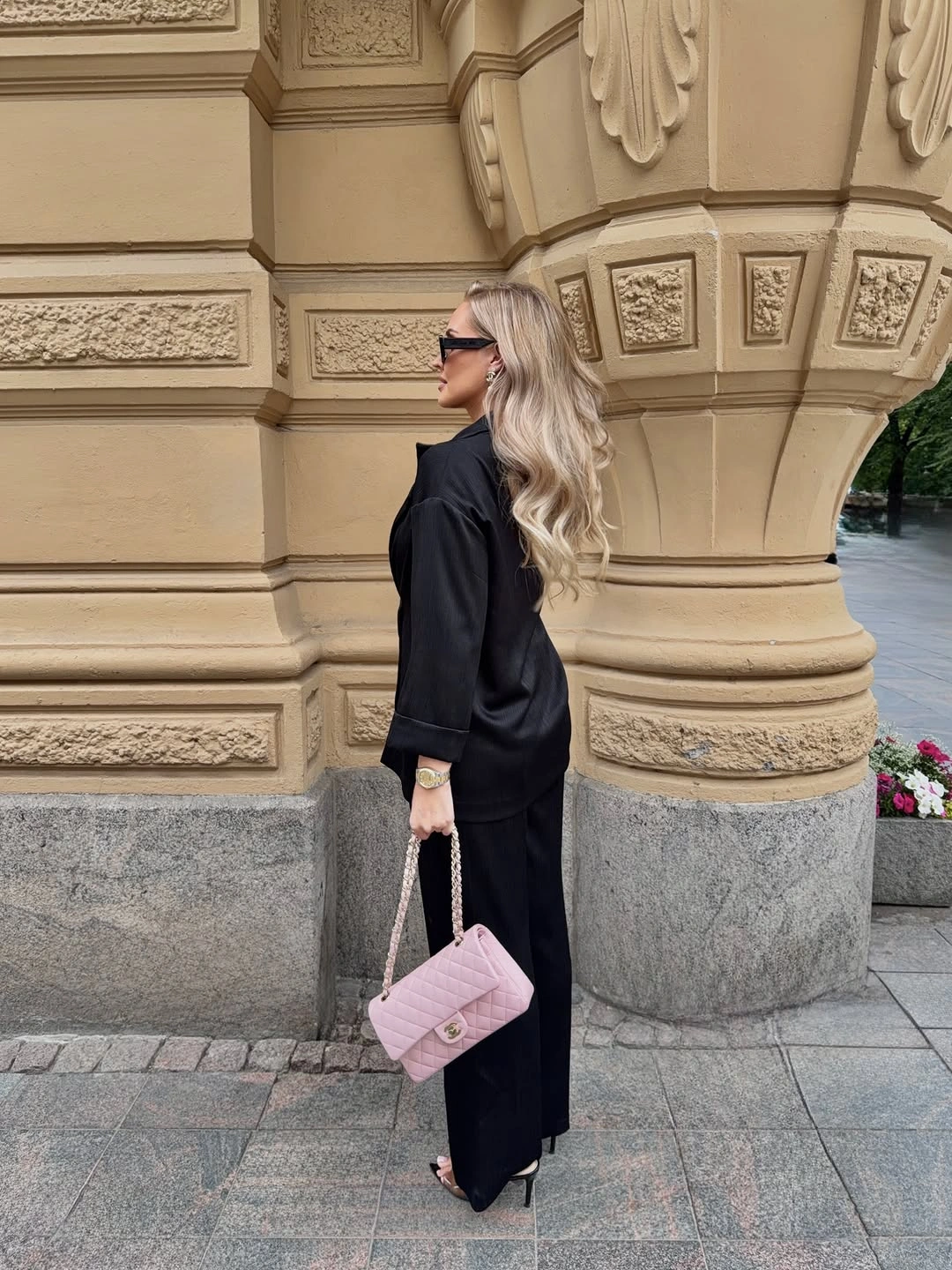 Black coordinated outfit with pale pink quilted chain bag
