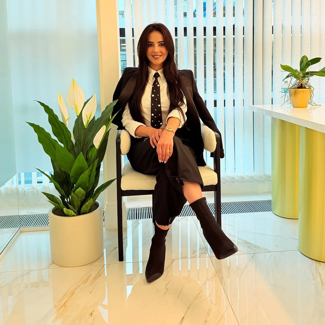 White shirt, dotted tie, black tailoring and tall boots