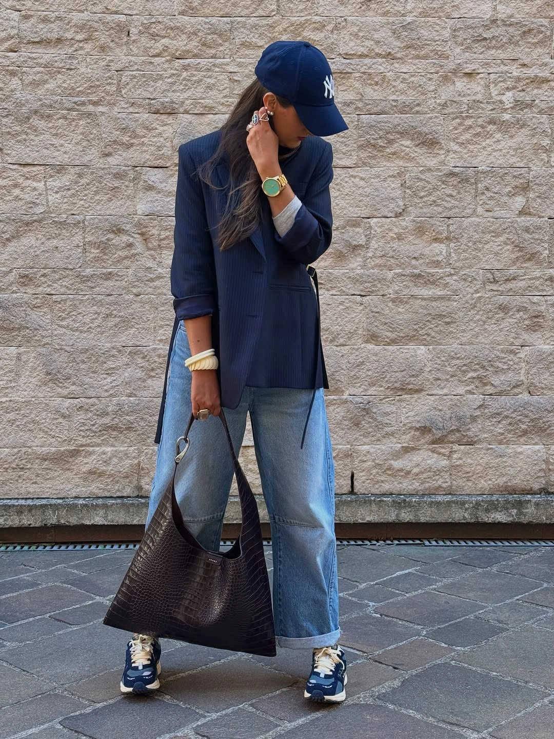 Navy blazer and cap with cuffed jeans and sneakers