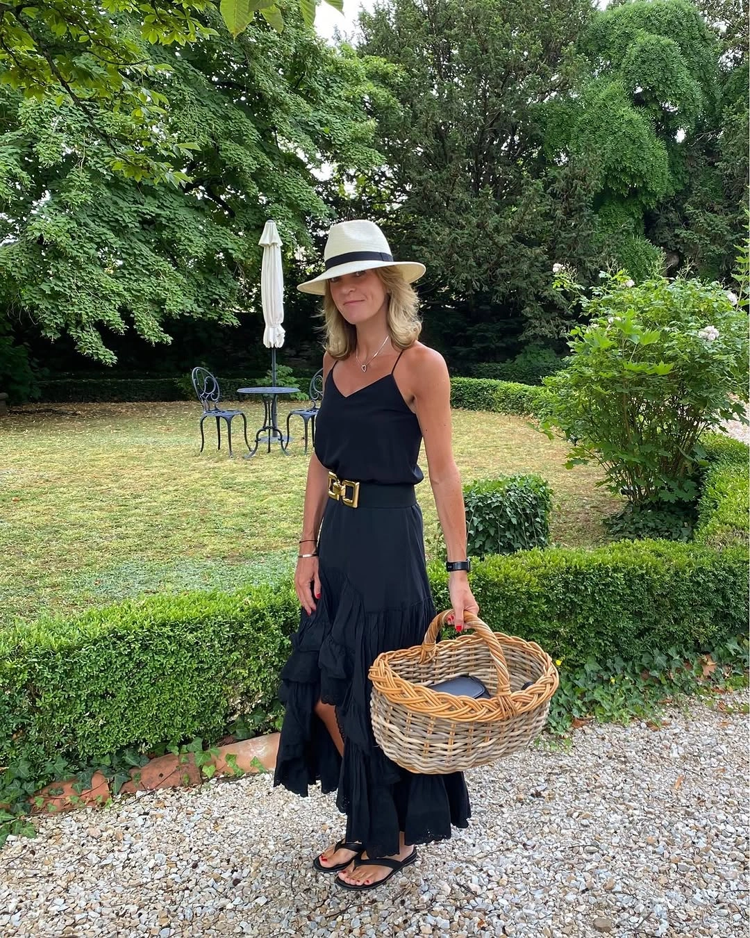 Black sleeveless belted outfit with hat and basket