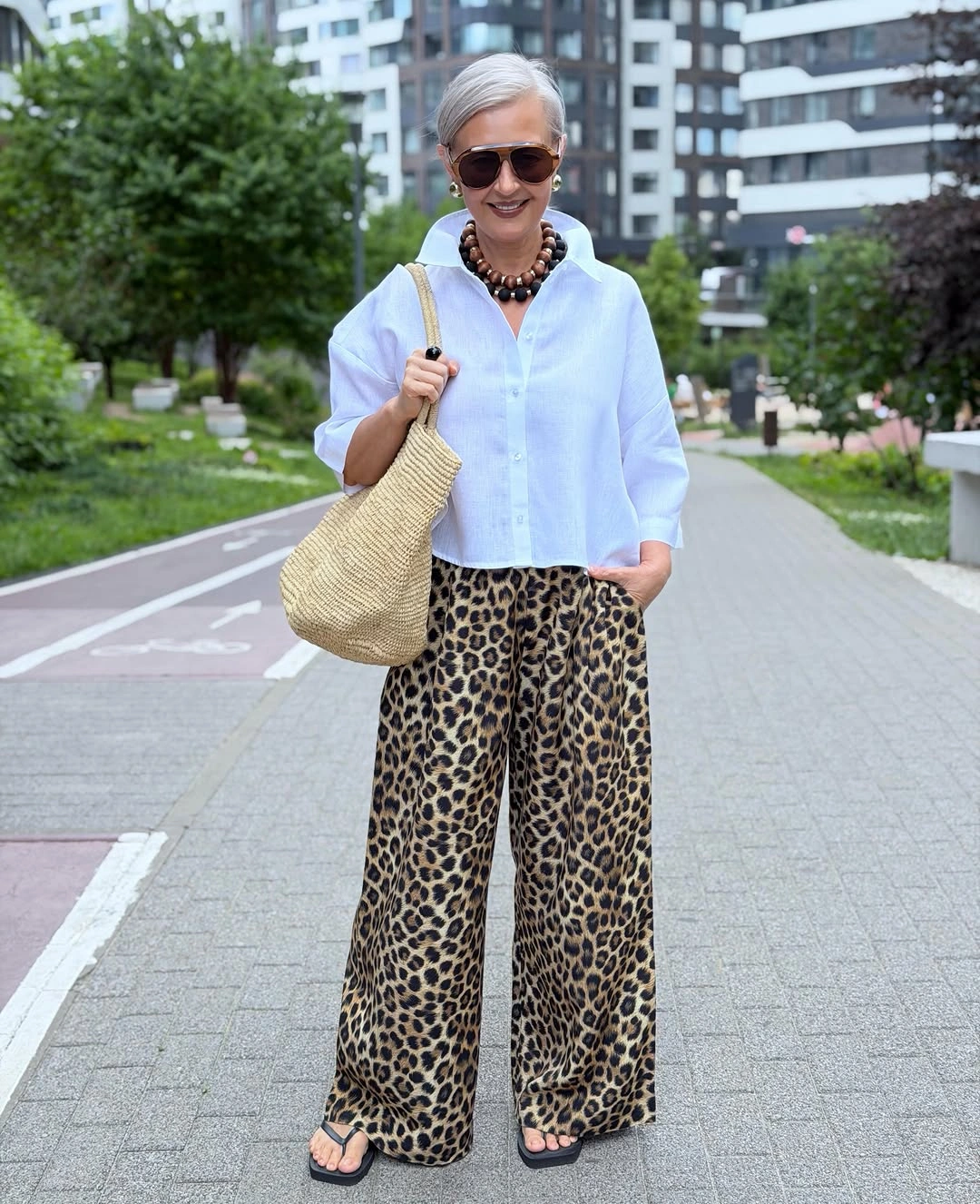 Cropped white shirt with leopard wide-leg pants and sandals