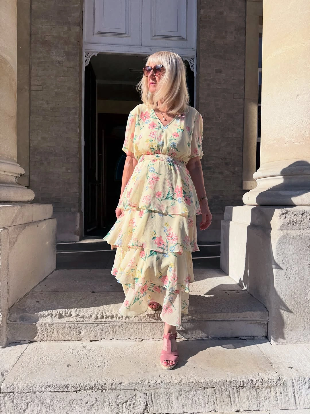 Pale floral tiered dress with pink heeled sandals