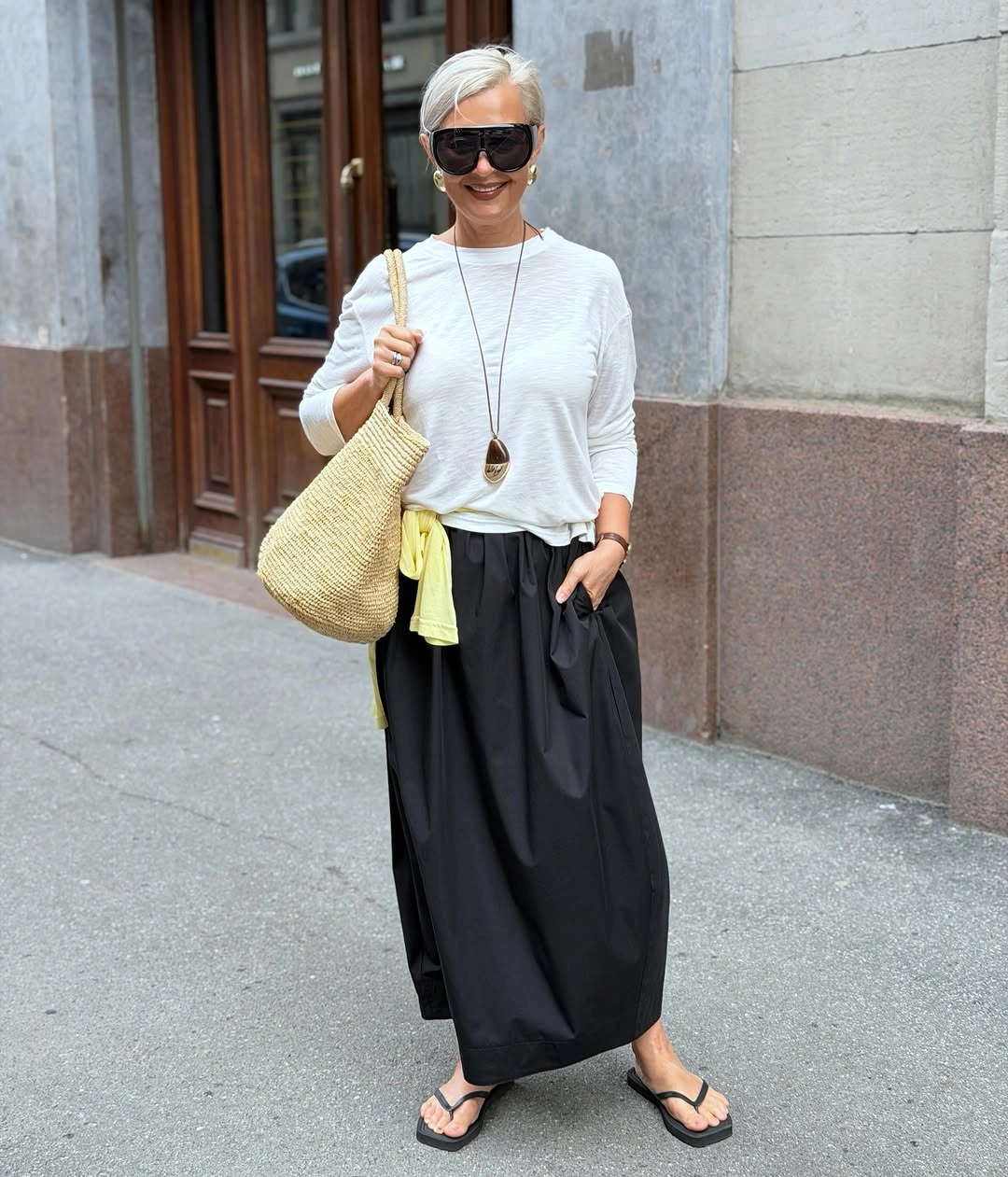 White top with black maxi skirt and yellow accent