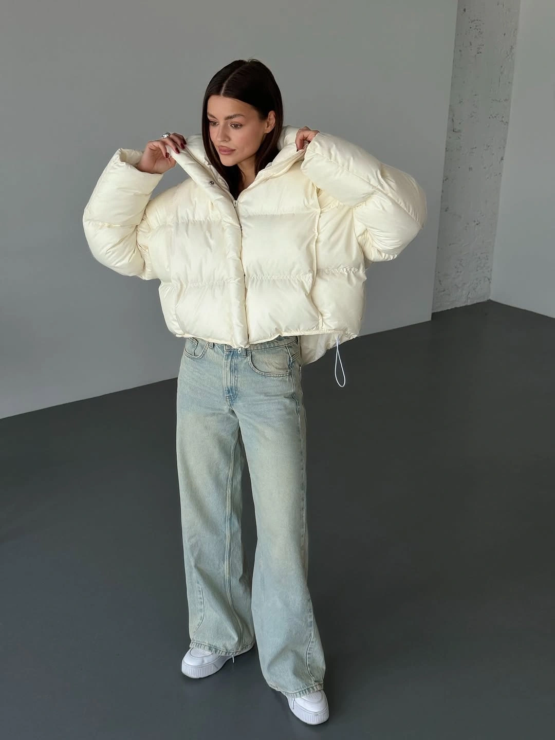 Cream white cropped puffer with wide pale blue jeans