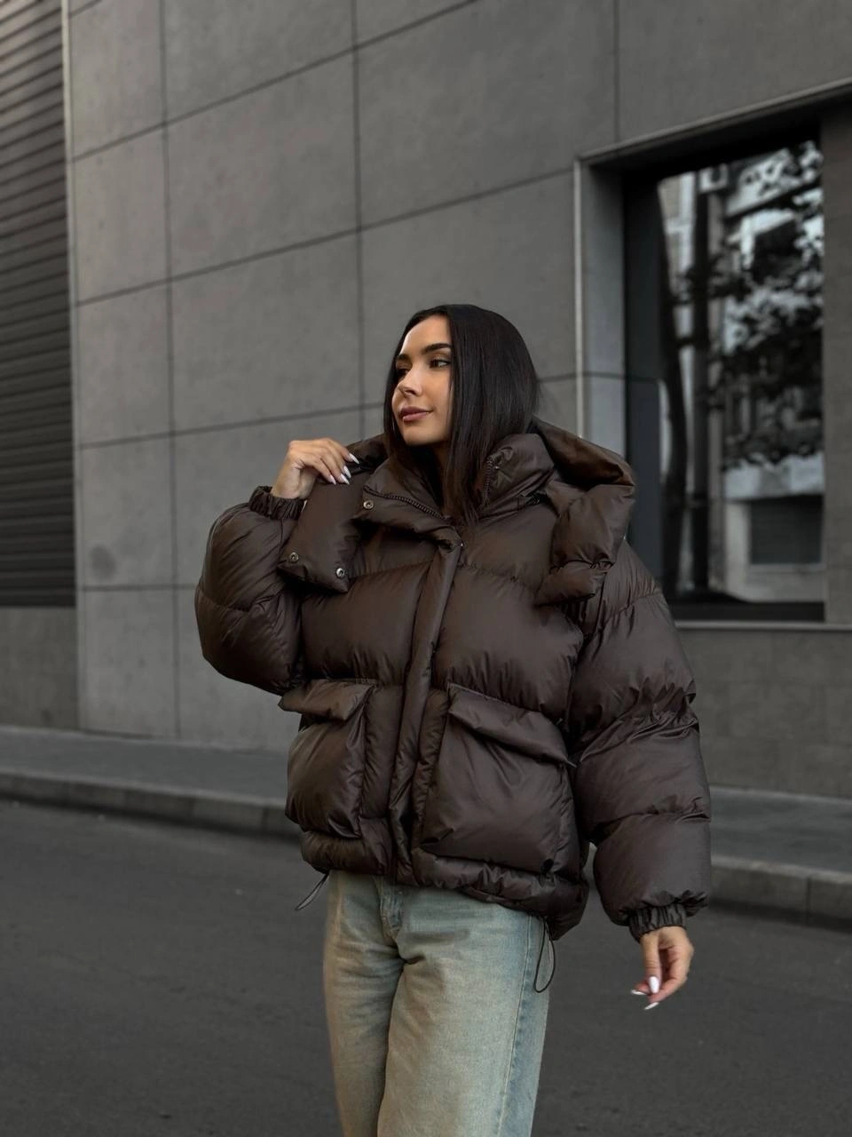 Dark brown oversized puffer with pale denim jeans