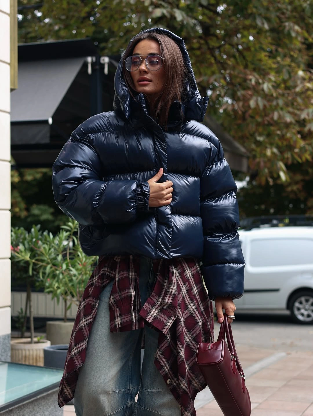 Glossy navy puffer with plaid shirt and gray denim