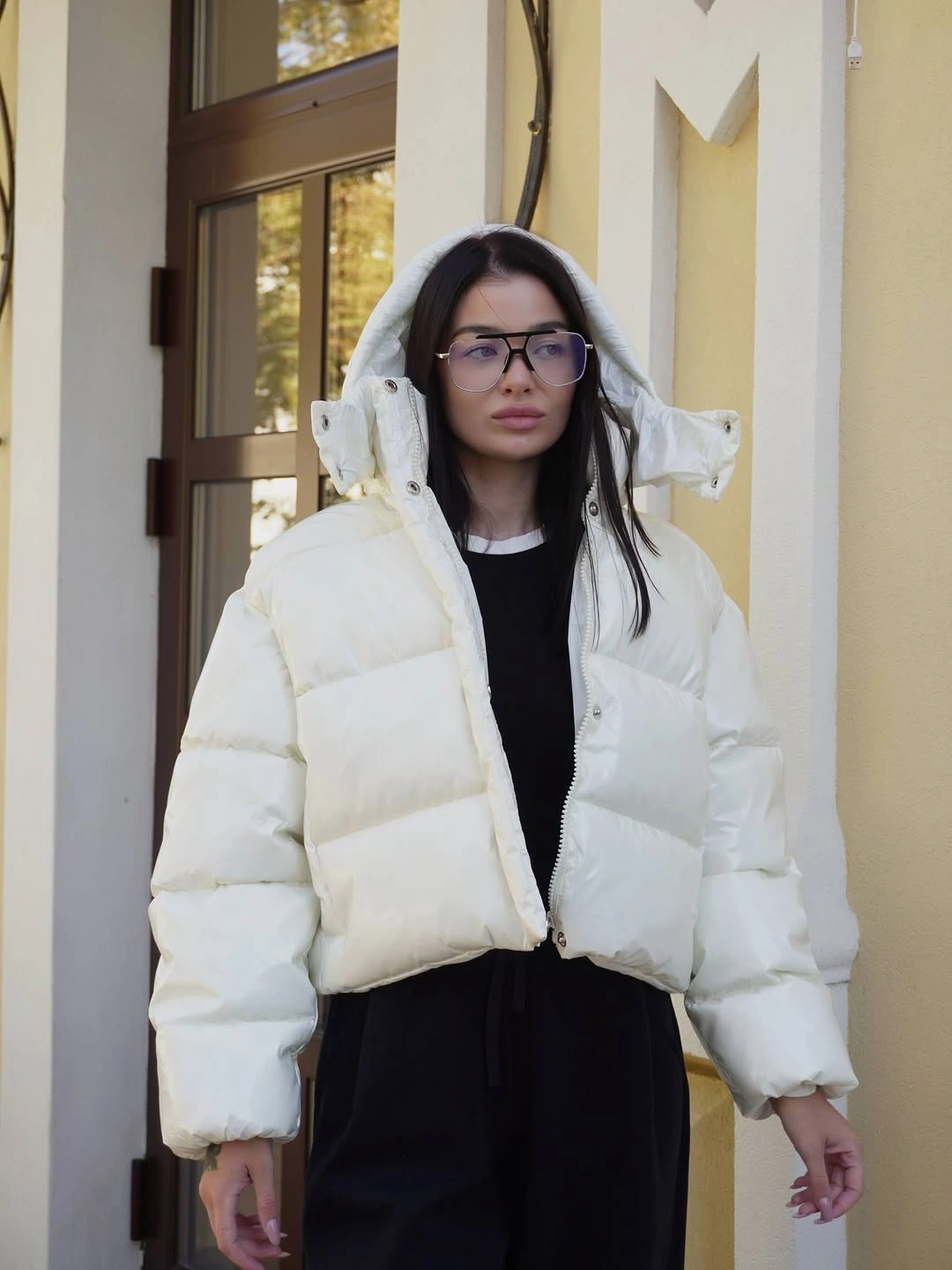 White puffer jacket over black top and dark loose bottoms
