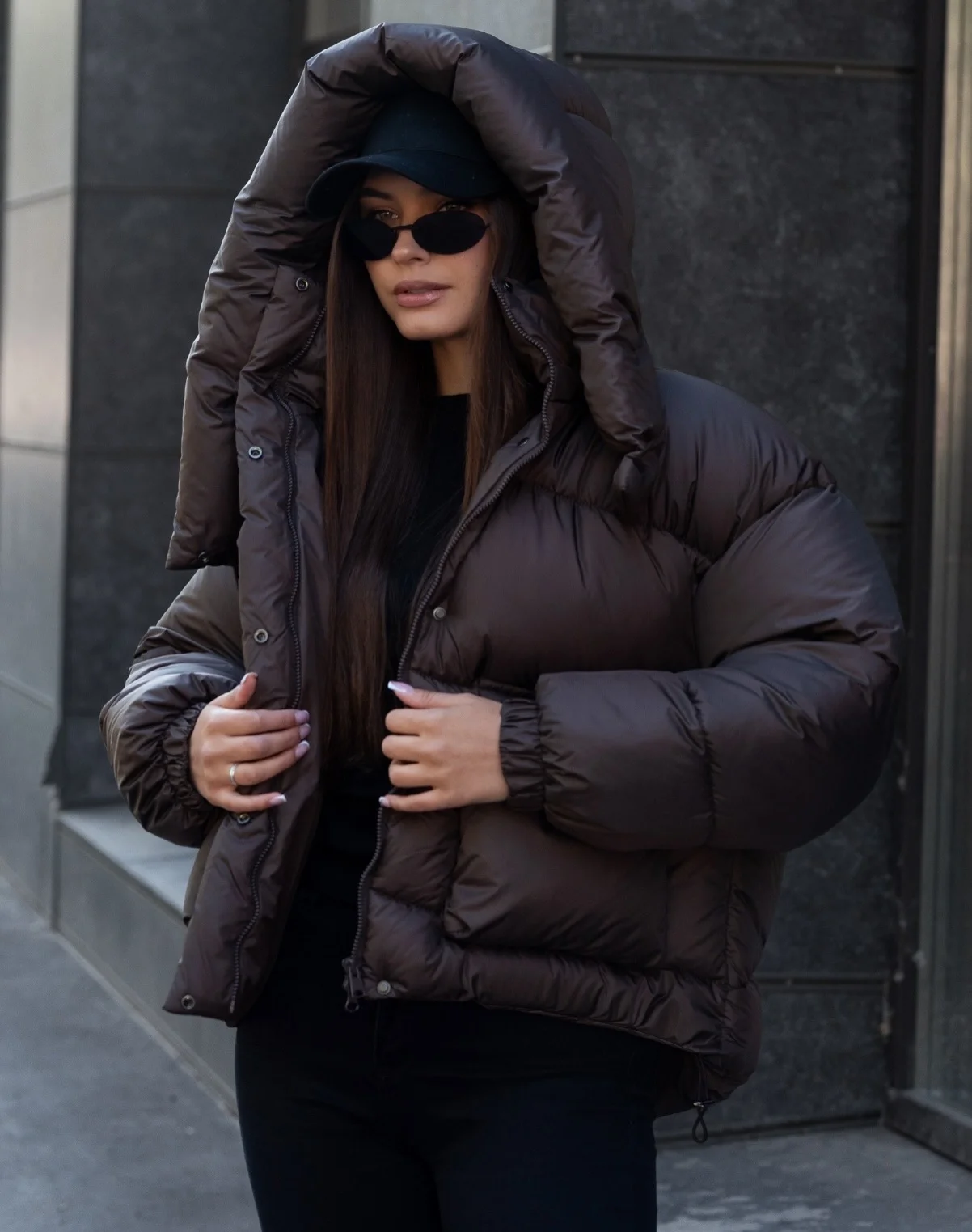 Dark hooded puffer over blue cap and black base