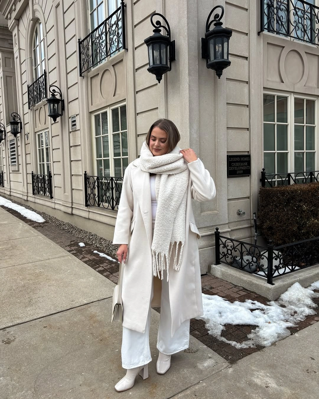 White coat and scarf with white trousers and heeled boots