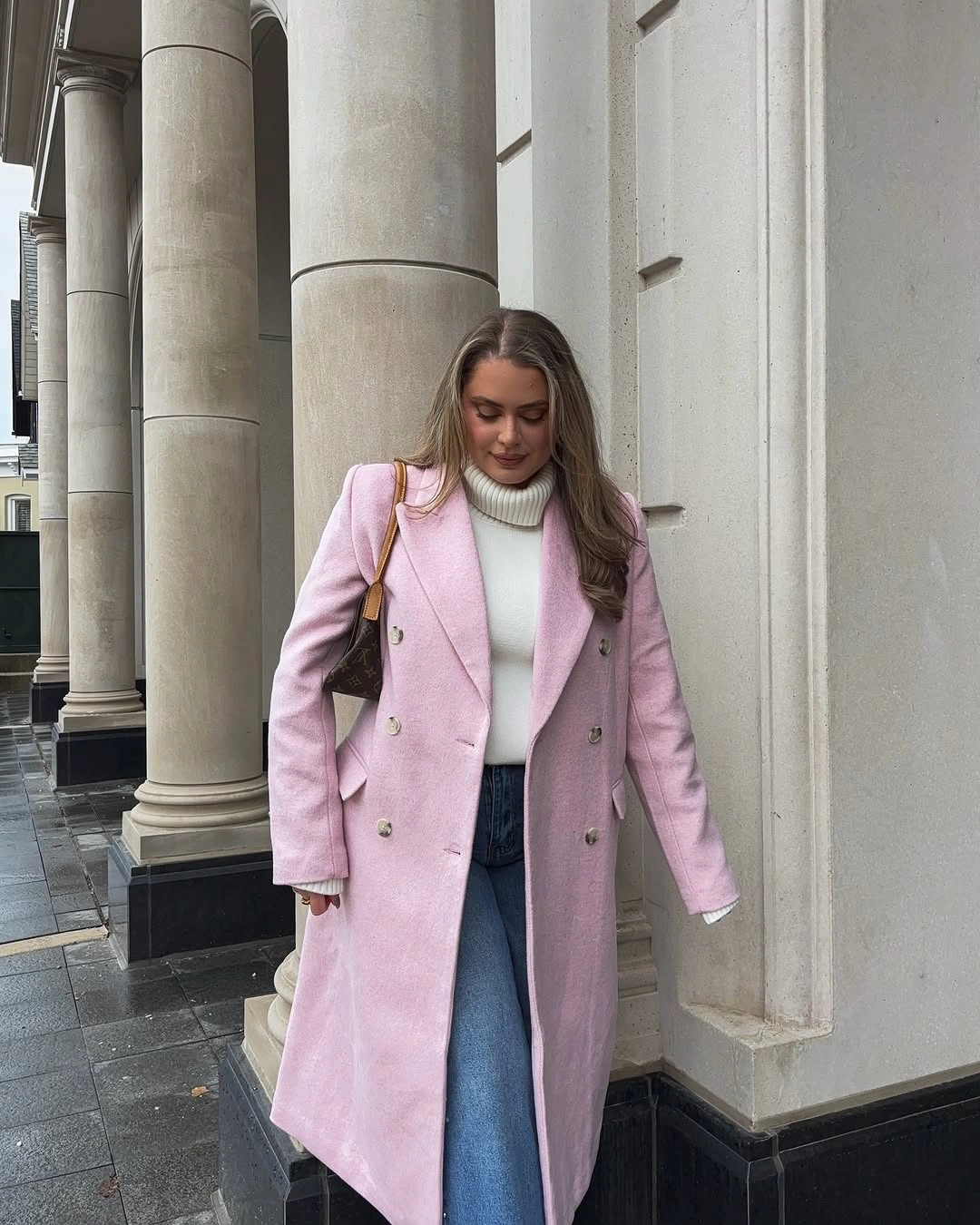 Pink long coat with white turtleneck and blue jeans