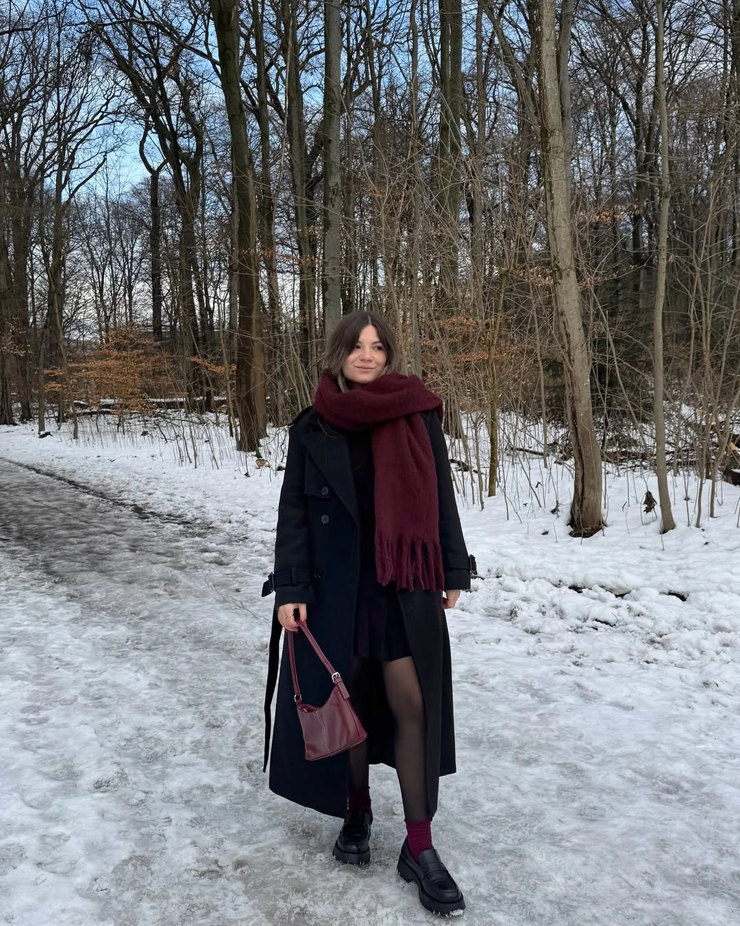 Black coat with burgundy scarf, short hem and pink bag