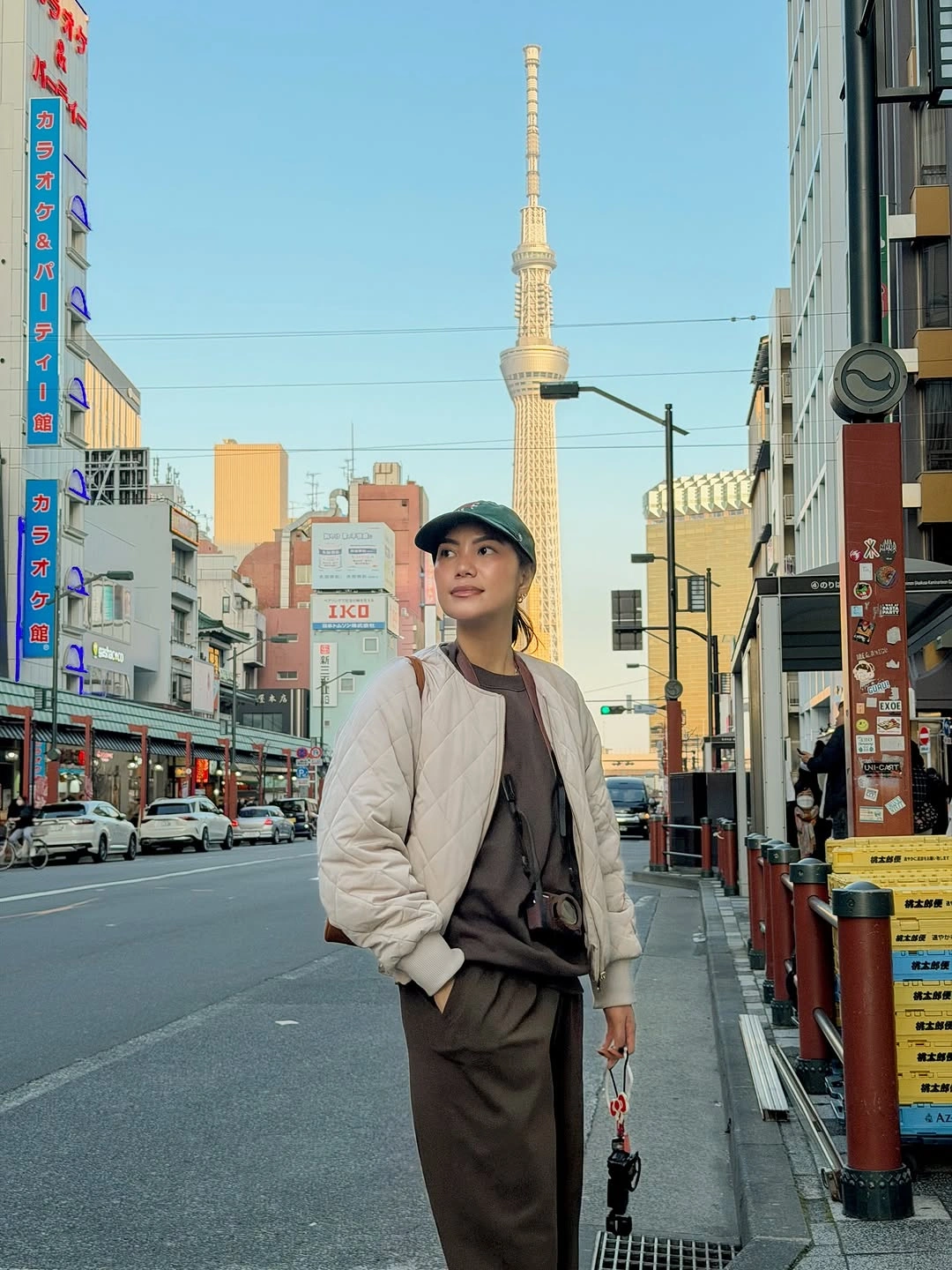 Cream quilted jacket over brown tonal layers and cap