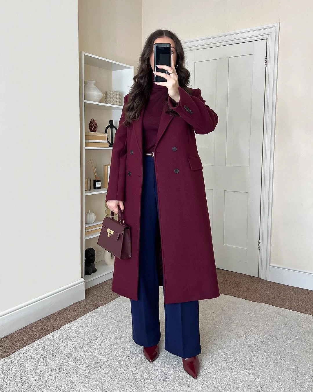 Burgundy long coat with royal blue trousers and pointed shoes