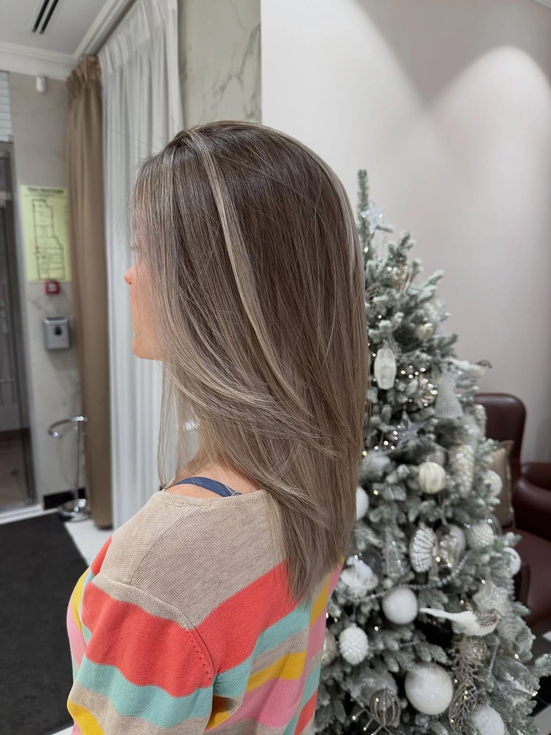 Shoulder length taupe brown hair with ash beige ribbons and side part