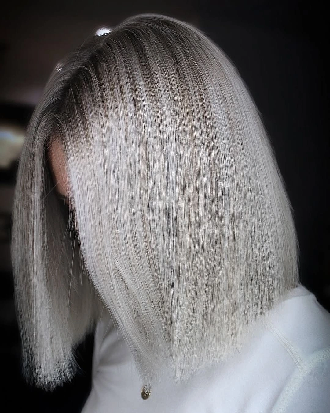 Compact straight silver grey bob with blunt edge and charcoal root