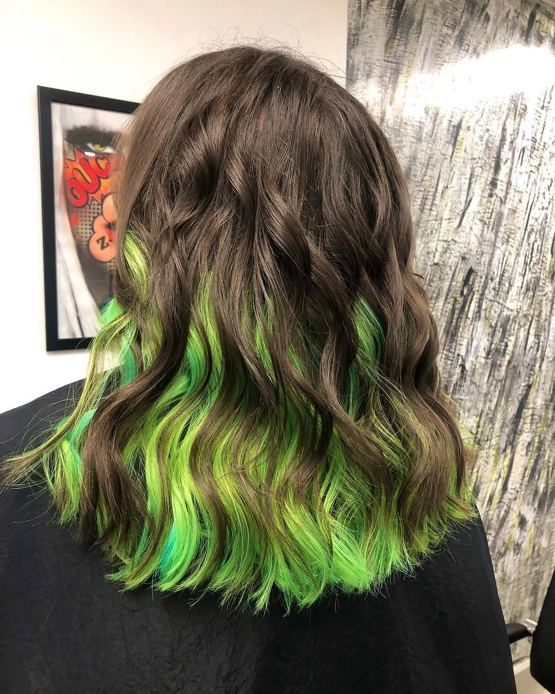 Long dark brown waves with lime emerald strands and uneven textured ends