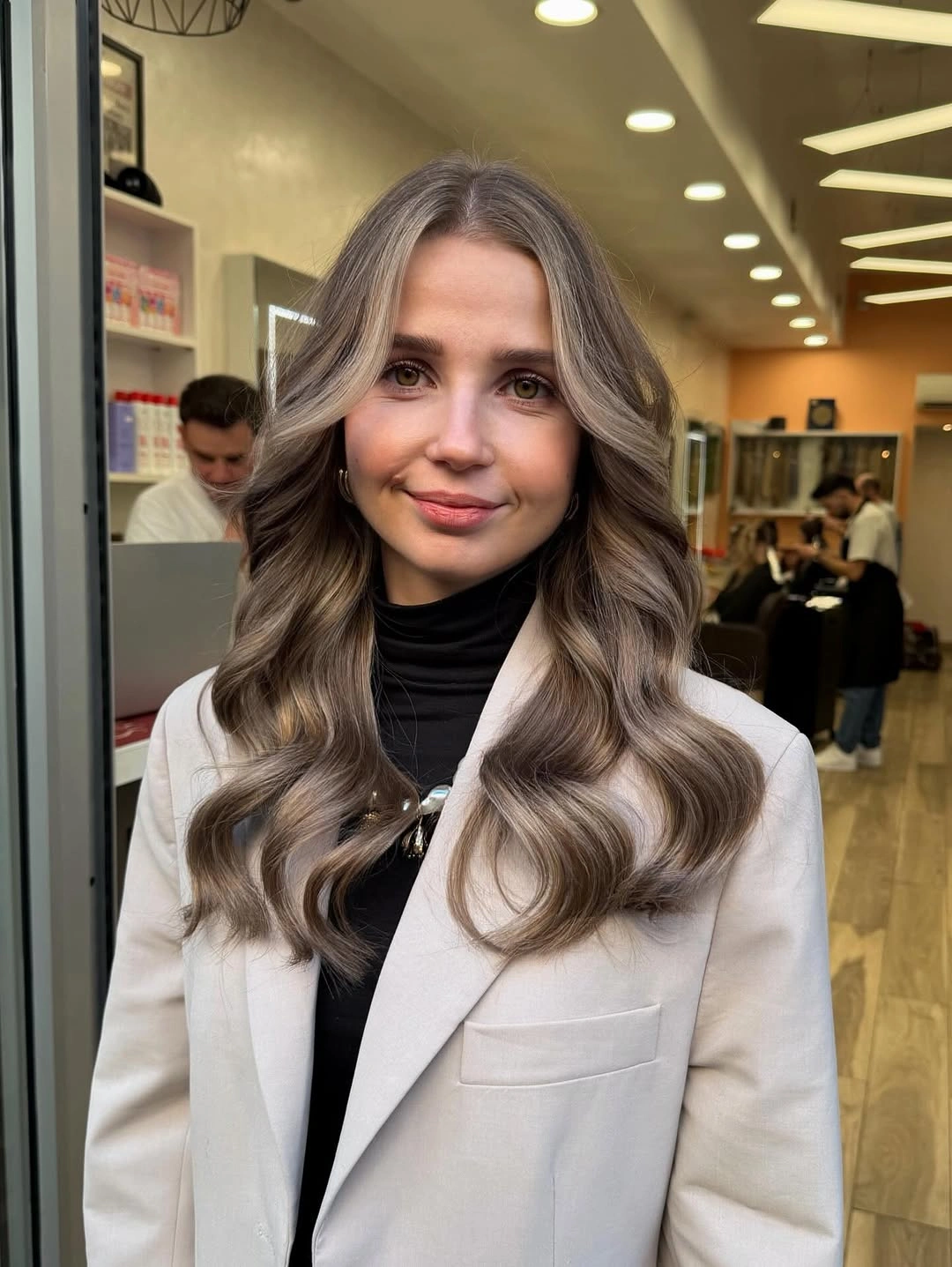 Long ash brown waves with beige grey face framing and curled ends