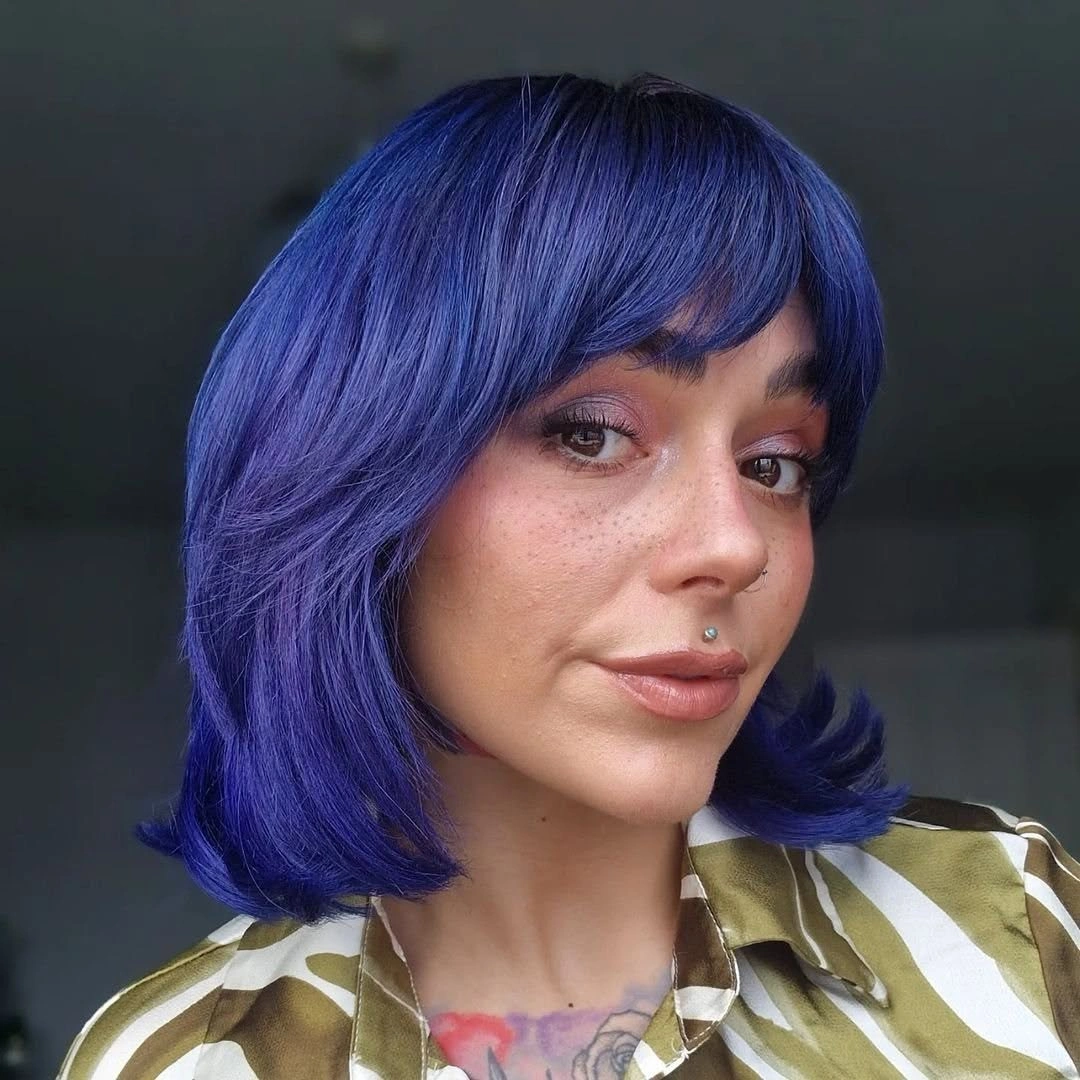 Short bob with cobalt indigo violet color and side swept fringe