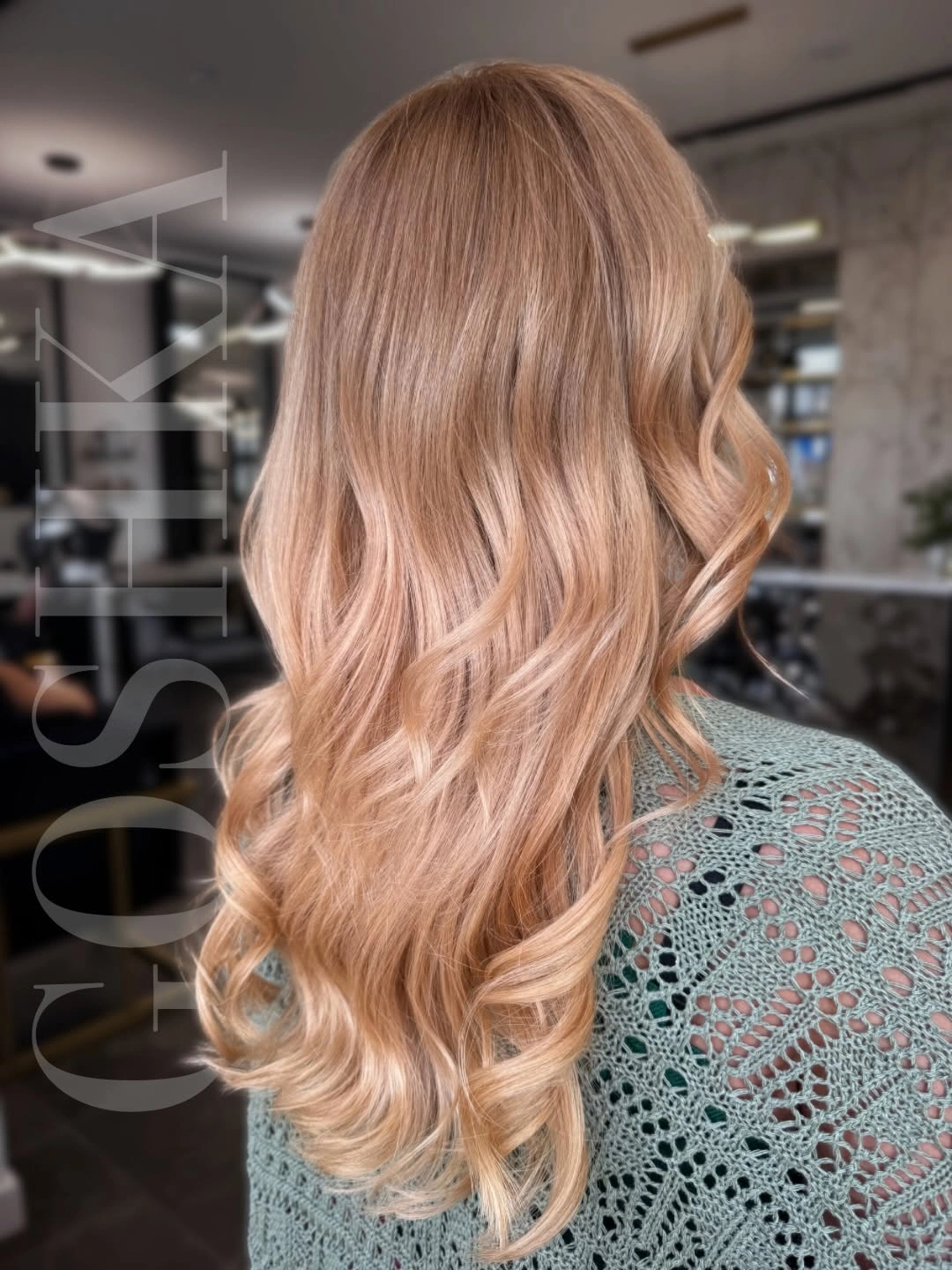 Long peach blonde waves with lighter curled ends