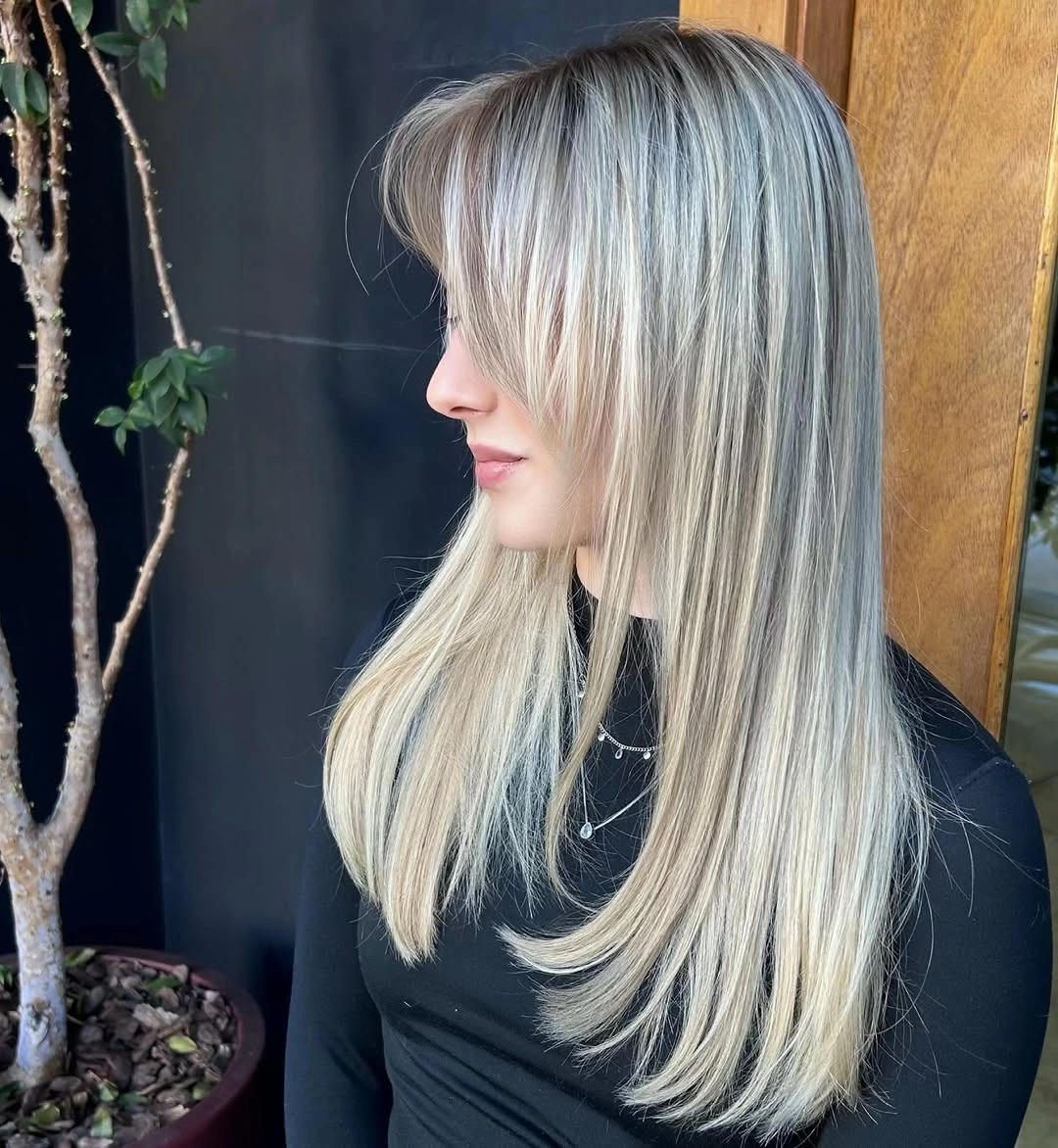 Long layered ash beige blonde hair with bright front pieces