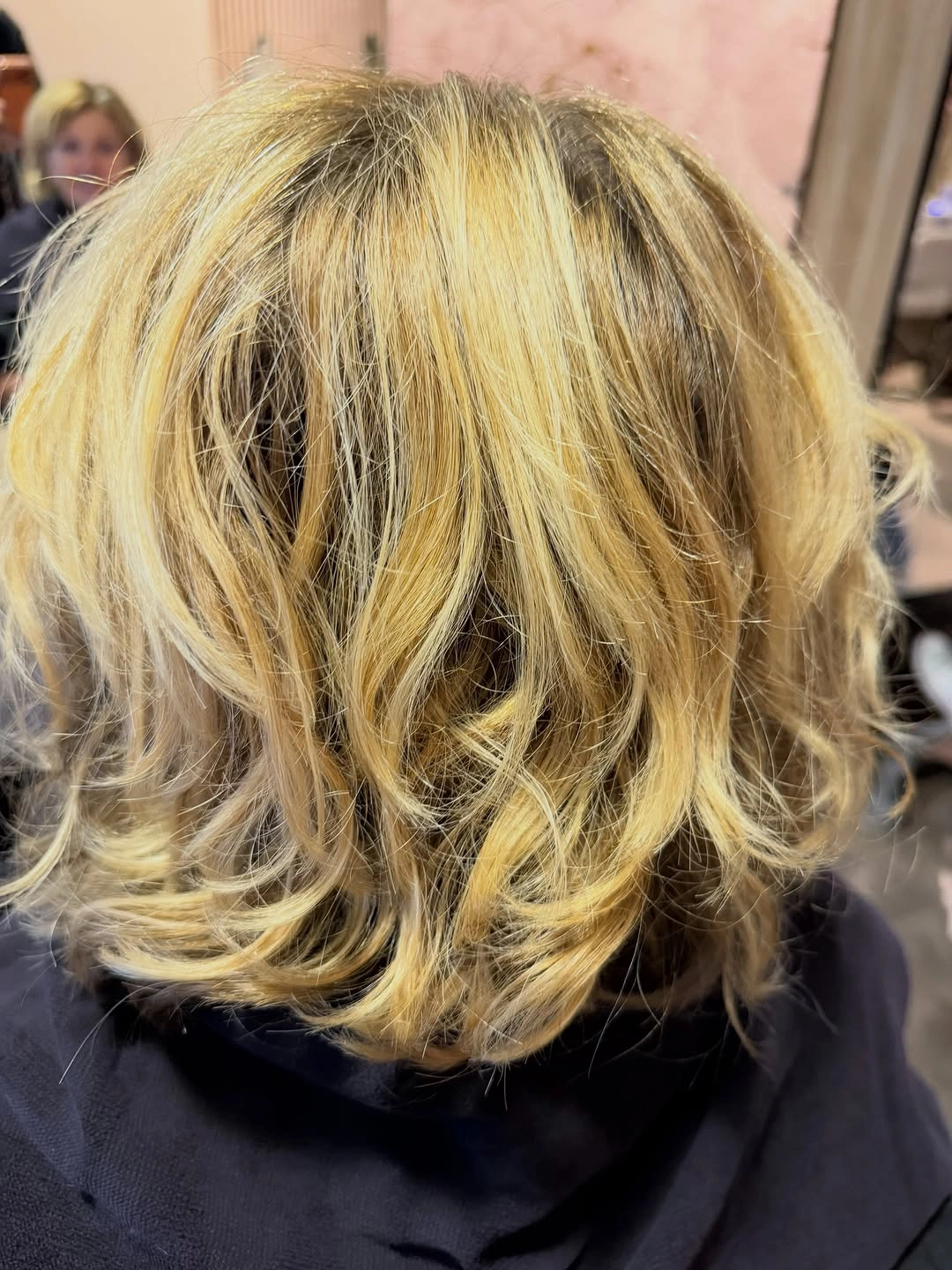 Short tousled blonde bob with dark base pieces