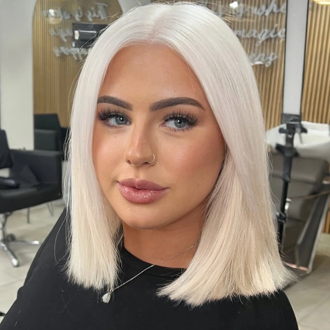 Creamy platinum blunt bob with straight center part